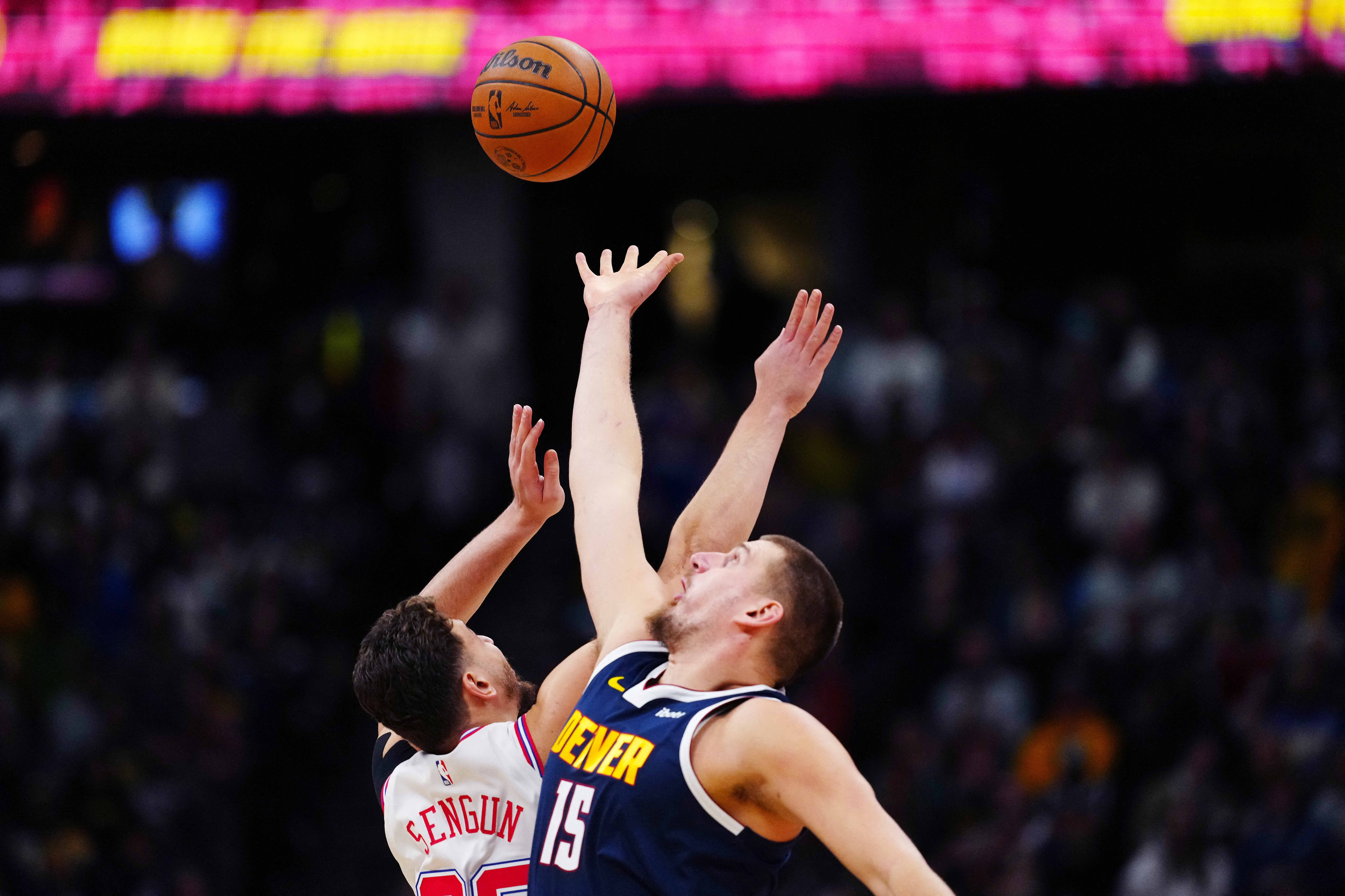 Dec 15, 2025; Denver, Colorado, USA; Houston Rockets center Alperen Sengun (28) and Denver Nuggets center Nikola Jokic (15) reach for the tip off in the first quarter at Ball Arena. Mandatory Credit: Ron Chenoy-Imagn Images