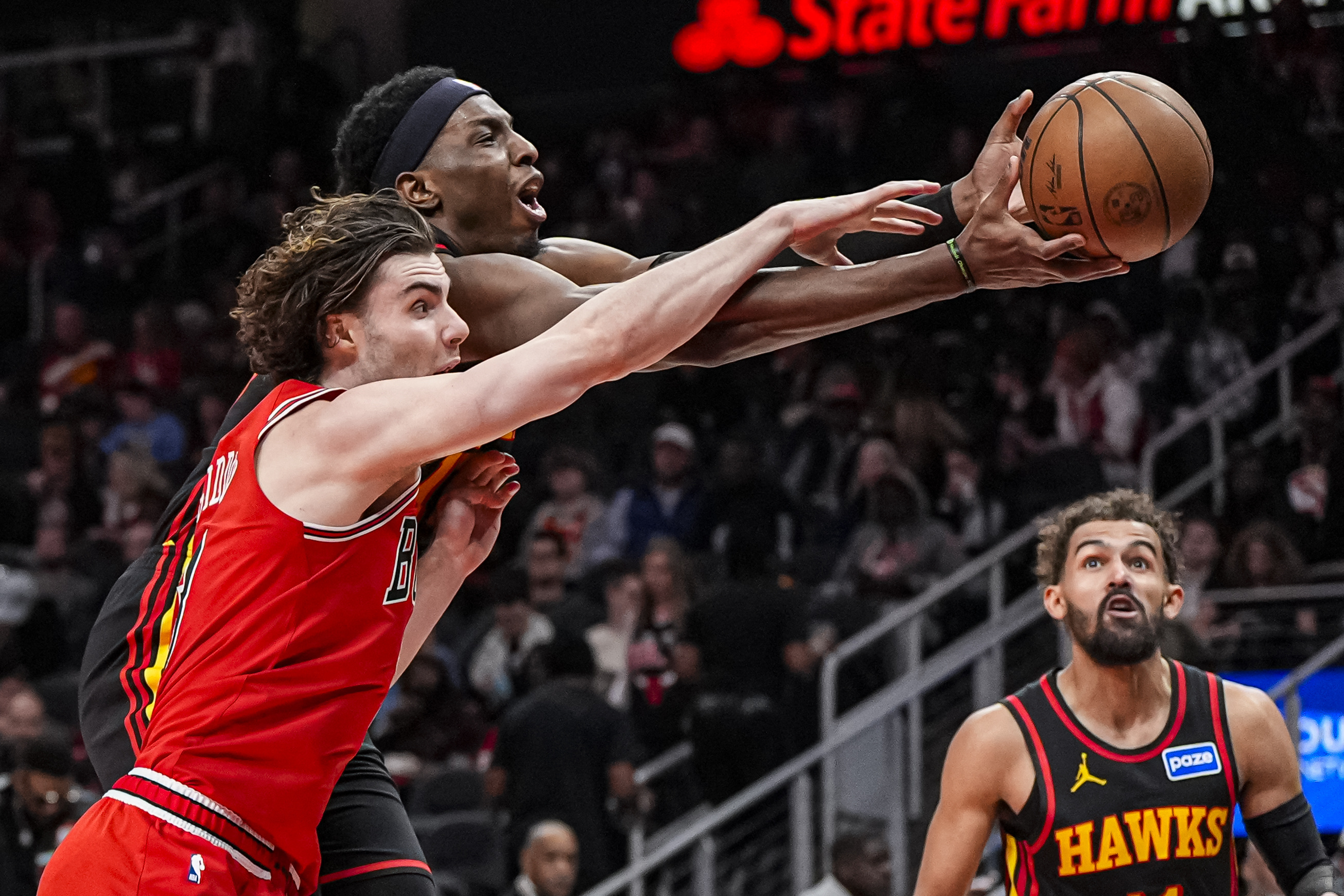 Dec 21, 2025; Atlanta, Georgia, USA; Atlanta Hawks forward Onyeka Okongwu (17) and Chicago Bulls guard Josh Giddey (3) battle for the ball during the second half at State Farm Arena. Mandatory Credit: Dale Zanine-Imagn Images