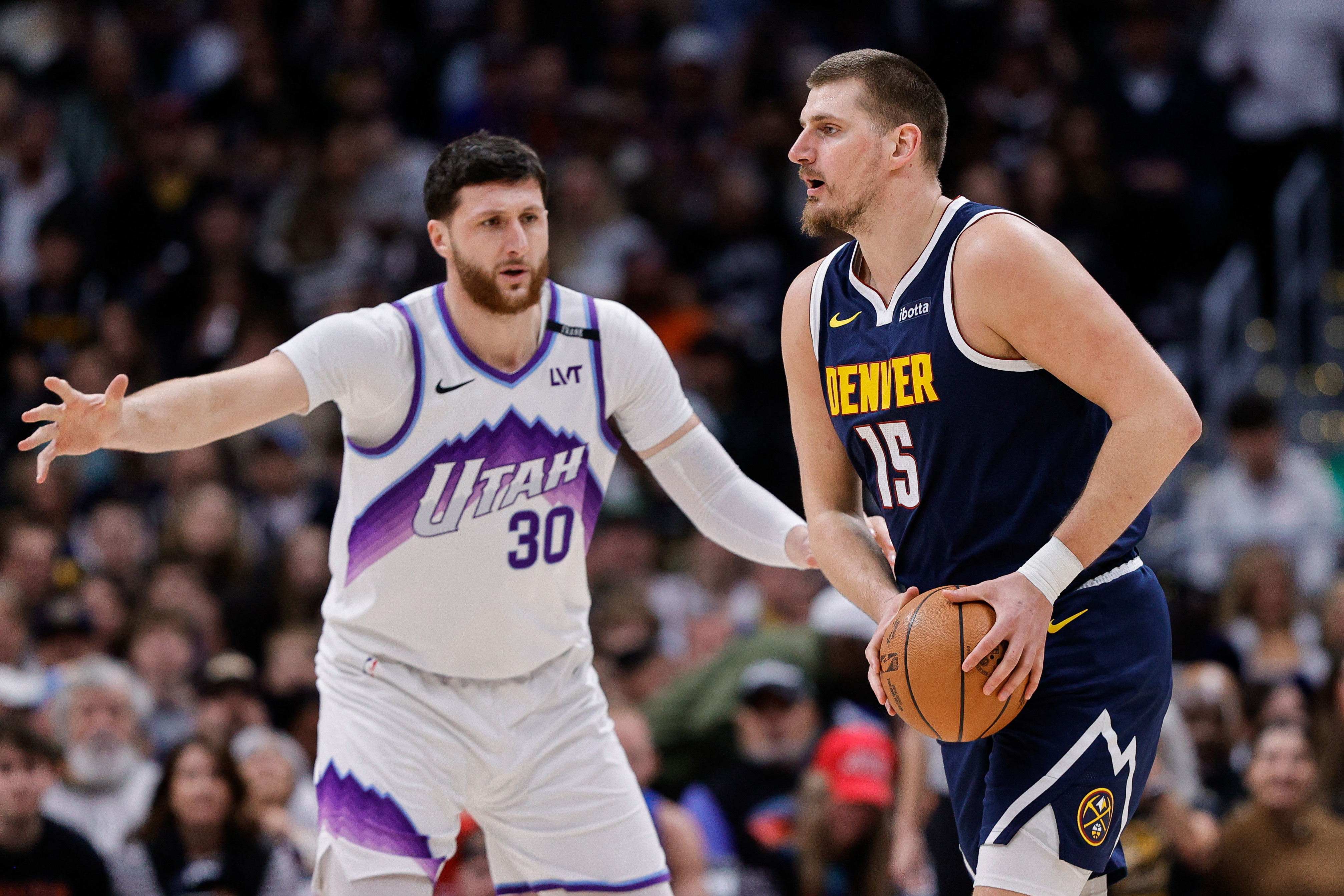Dec 22, 2025; Denver, Colorado, USA; Denver Nuggets center Nikola Jokić (15) controls the ball as Utah Jazz center Jusuf Nurkić (30) guards in the first quarter at Ball Arena. Mandatory Credit: Isaiah J. Downing-Imagn Images