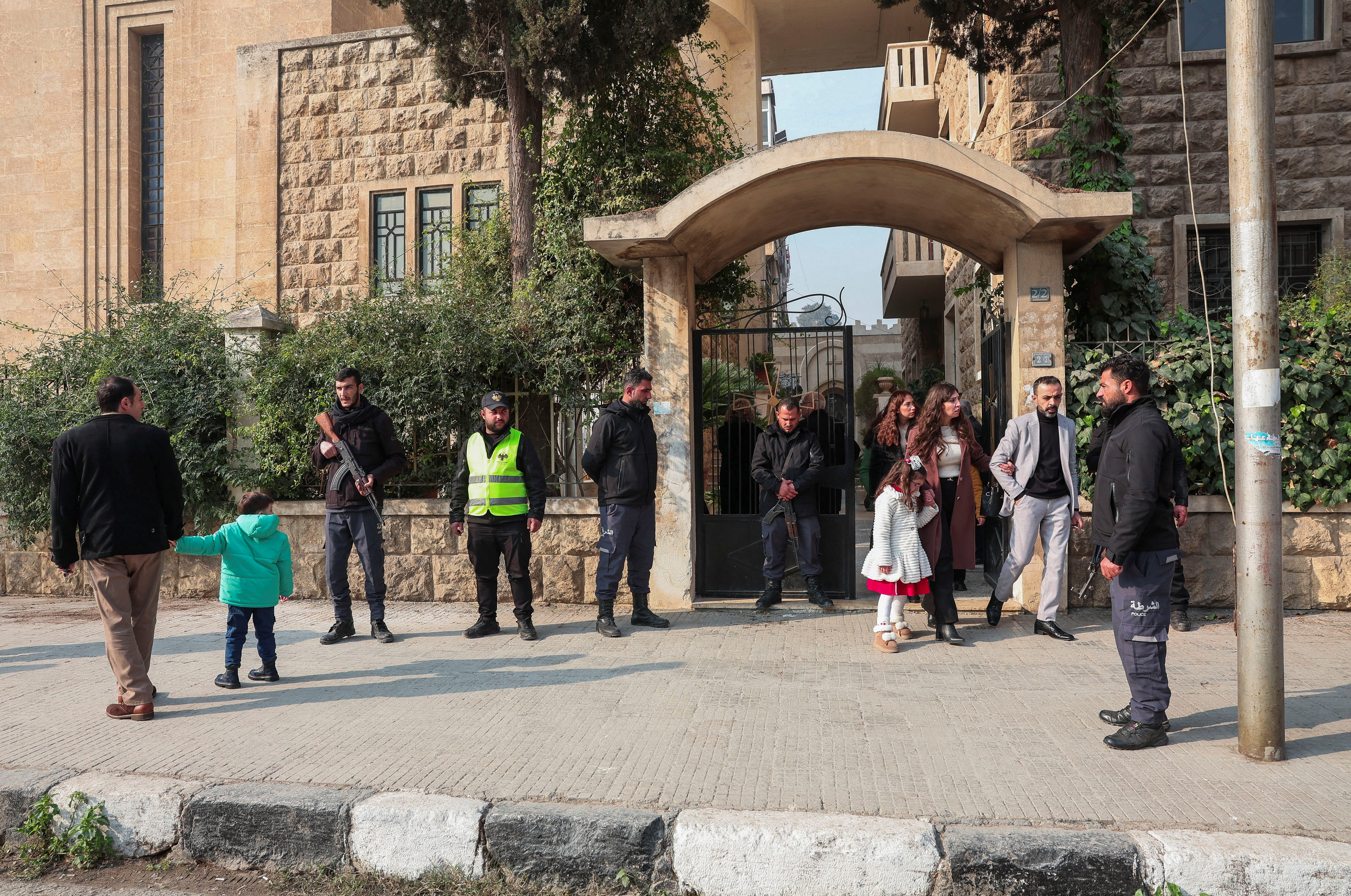 Members of the security forces stand in front of the St. Joseph Chaldean Cathedral