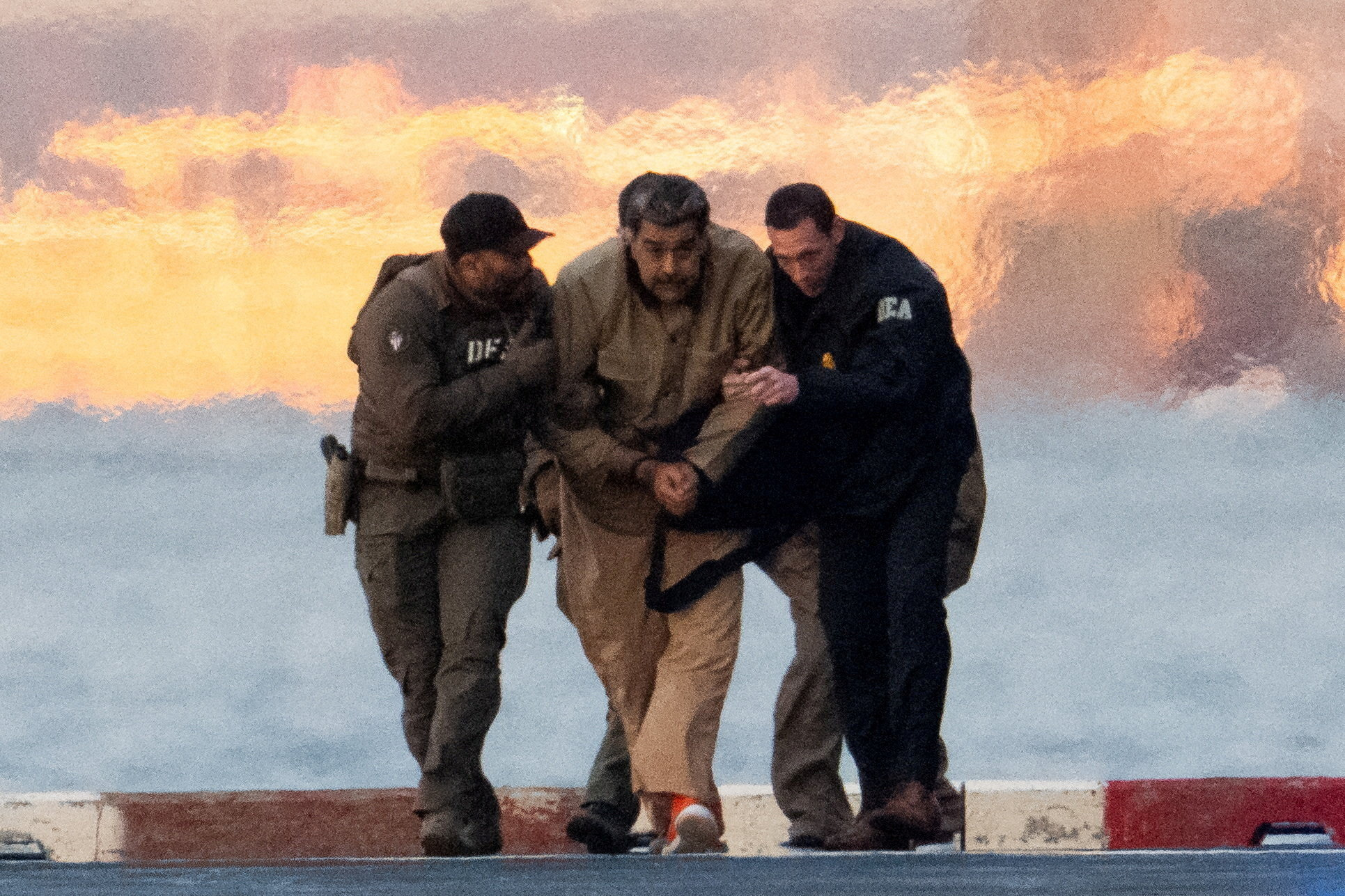 Captured Venezuelan President Nicolas Maduro is escorted