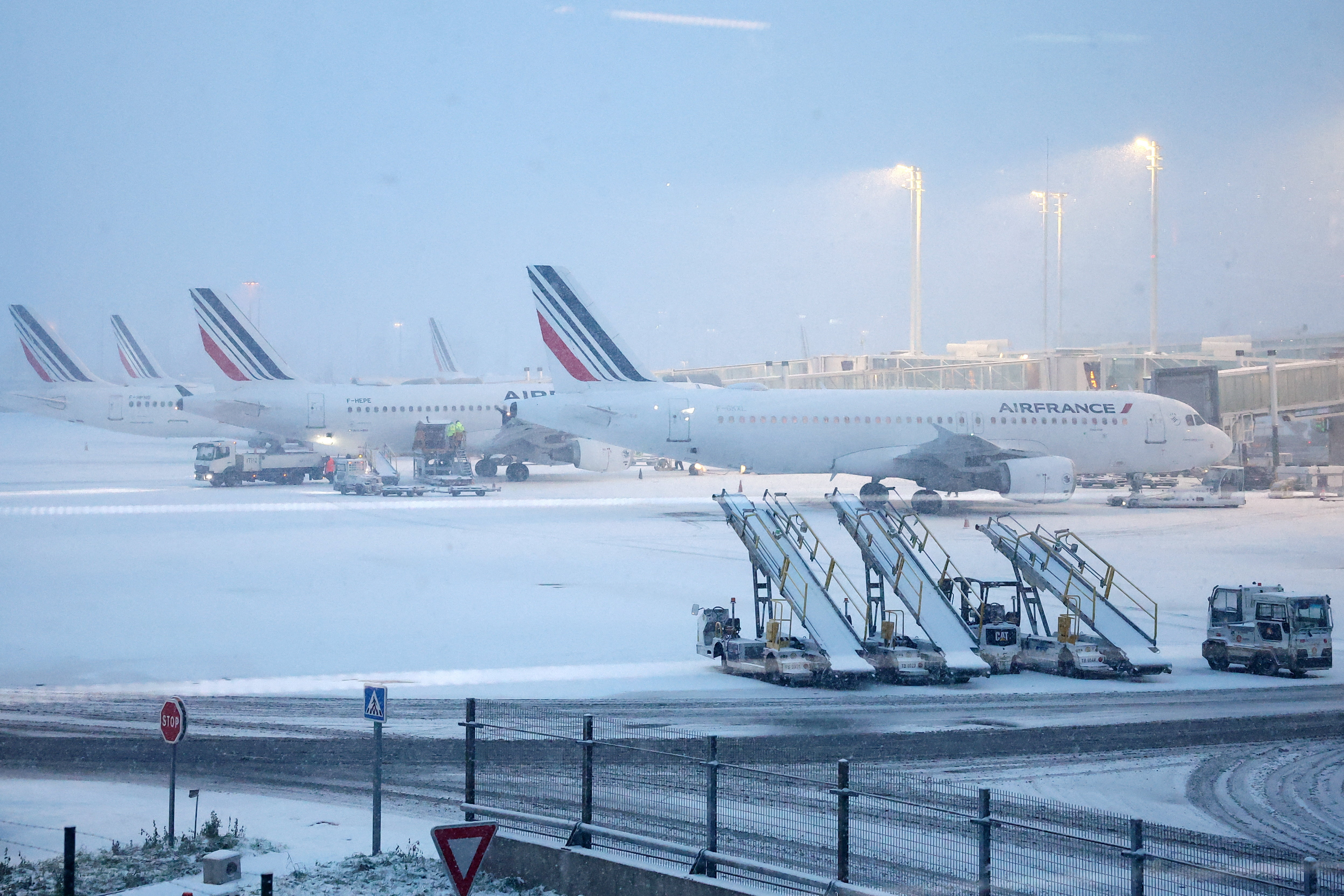 View of Air France planes on the snow-covered tarmac at the Paris CDG Terminal 2F of the Paris-Charles de Gaulle Airport, in Roissy-en-France, near Paris