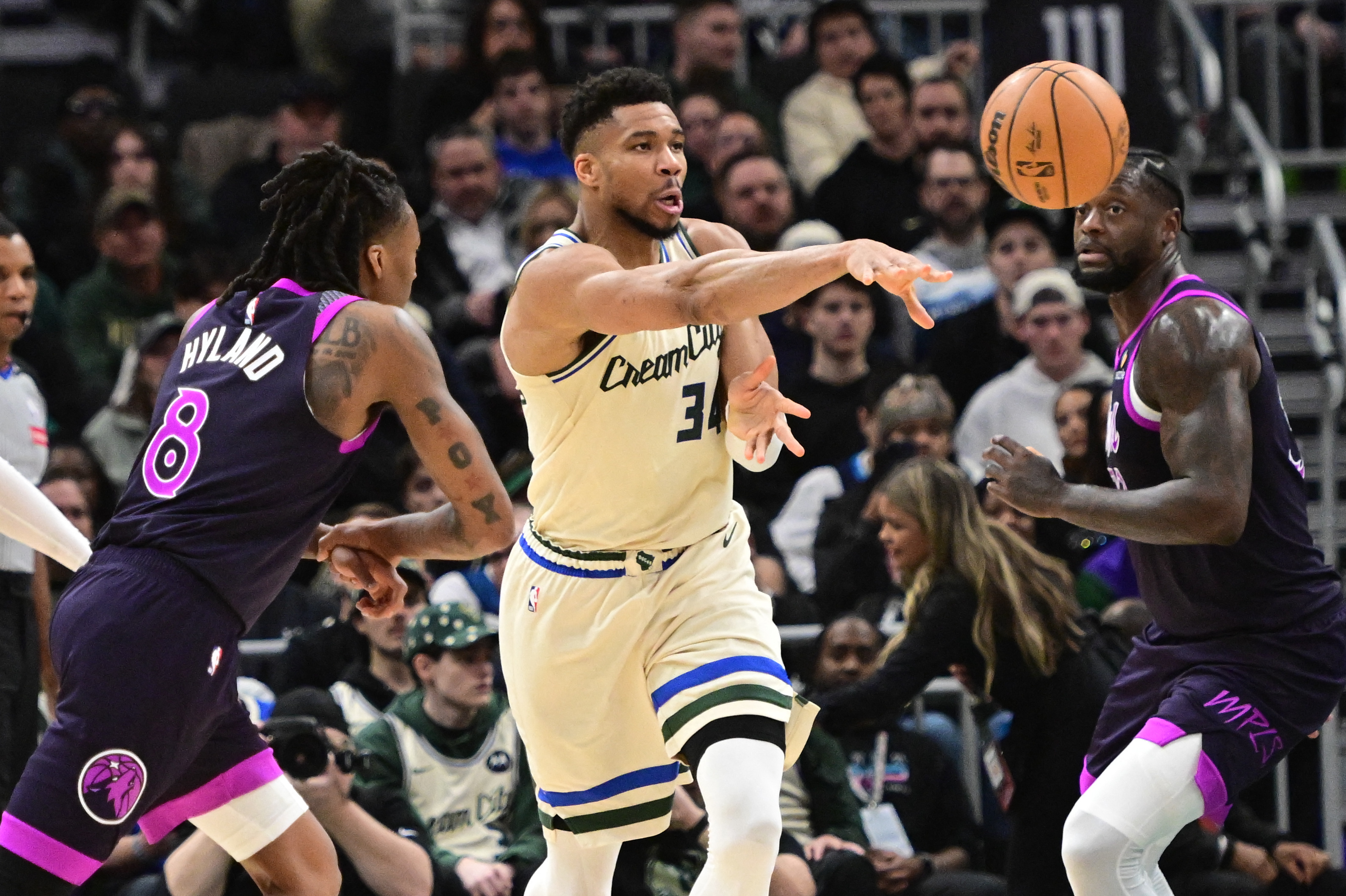 Jan 13, 2026; Milwaukee, Wisconsin, USA; Milwaukee Bucks forward Giannis Antetokounmpo (34) passes the ball away from Minnesota Timberwolves guard Bones Hyland (8) in the second quarter at Fiserv Forum. Mandatory Credit: Benny Sieu-Imagn Images