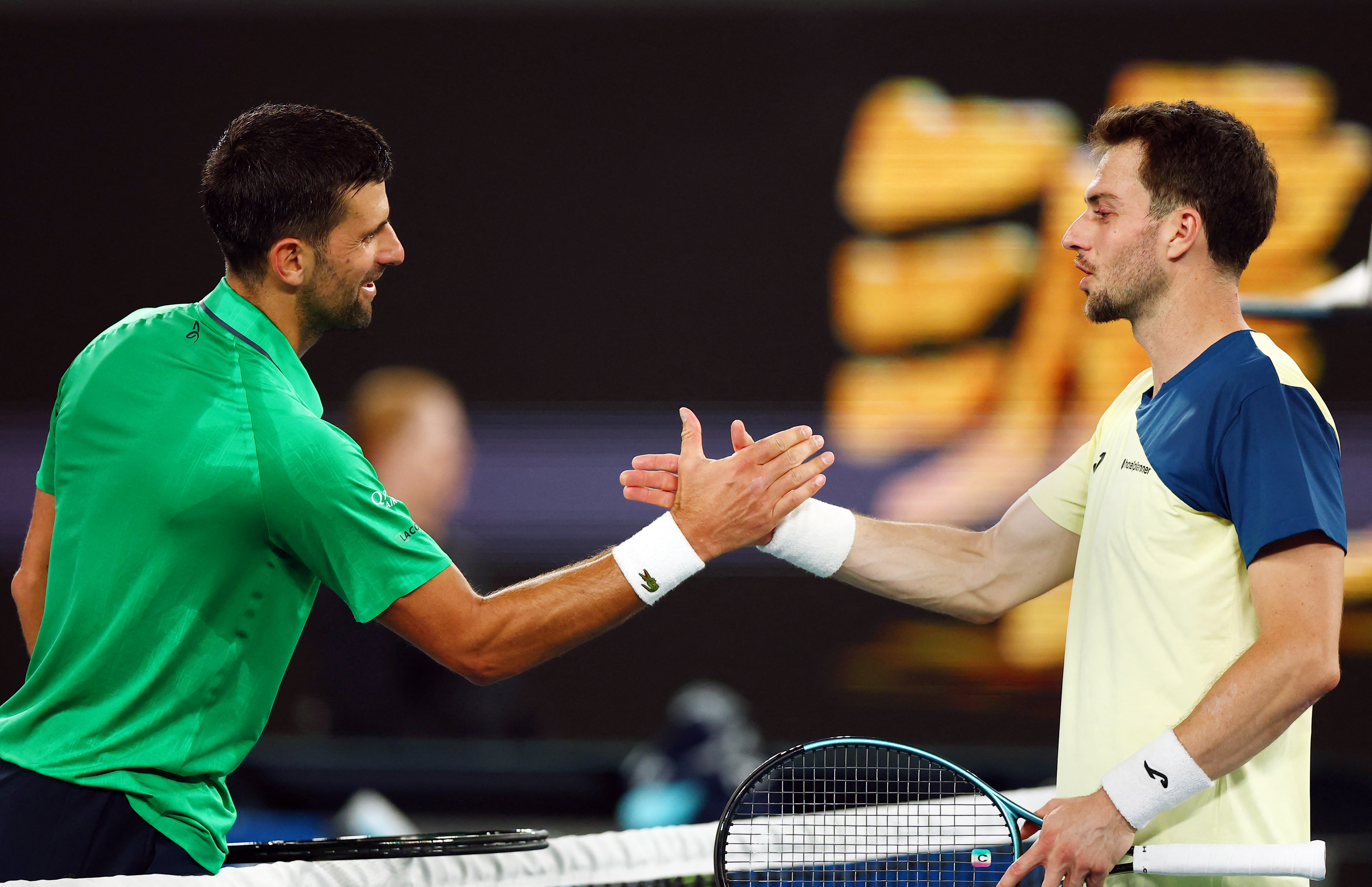 Tennis - Australian Open - Melbourne Park, Melbourne, Australia - January 19, 2026 Serbia's Novak Djokovic shakes hands with Spain's Pedro Martinez after winning their first round match REUTERS/Tingshu Wang