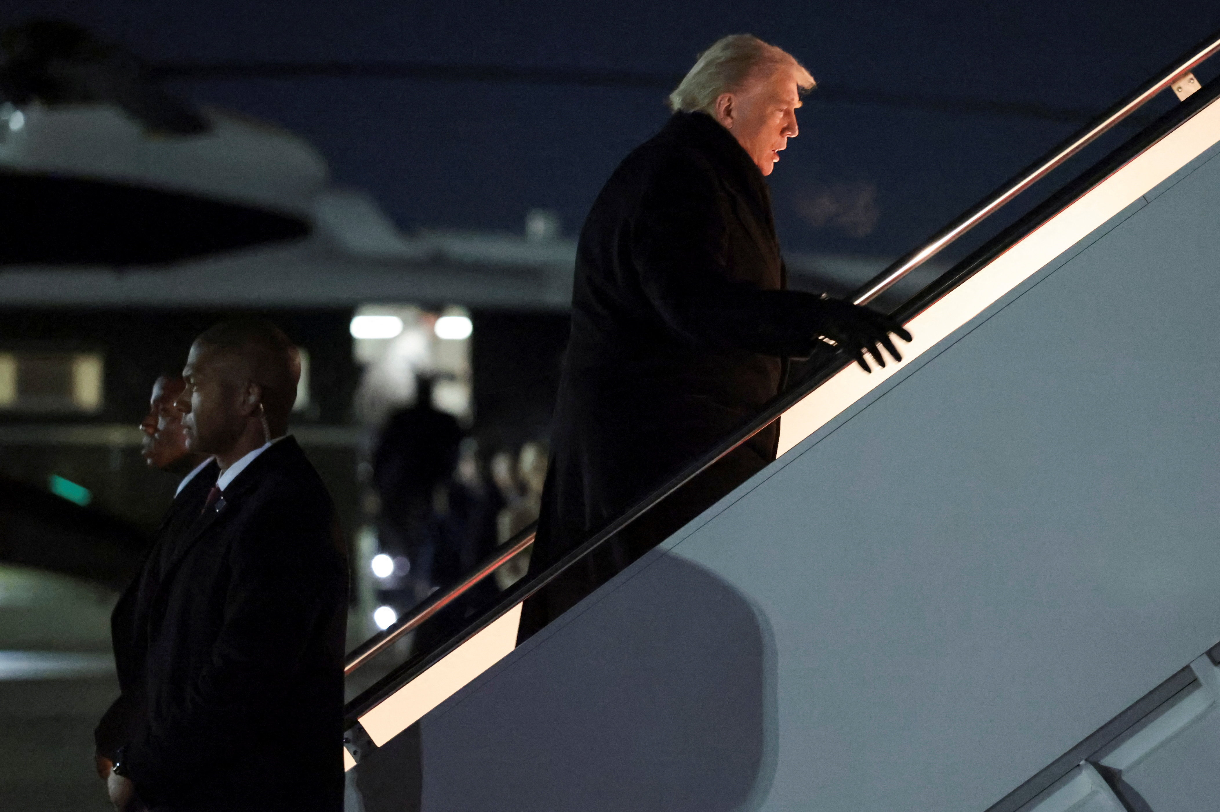 U.S. President Donald Trump boards Air Force One for travel to the World Economic Forum in Davos, Switzerland, from Joint Base Andrews, Maryland, U.S., January 20, 2026. REUTERS/Jonathan Ernst