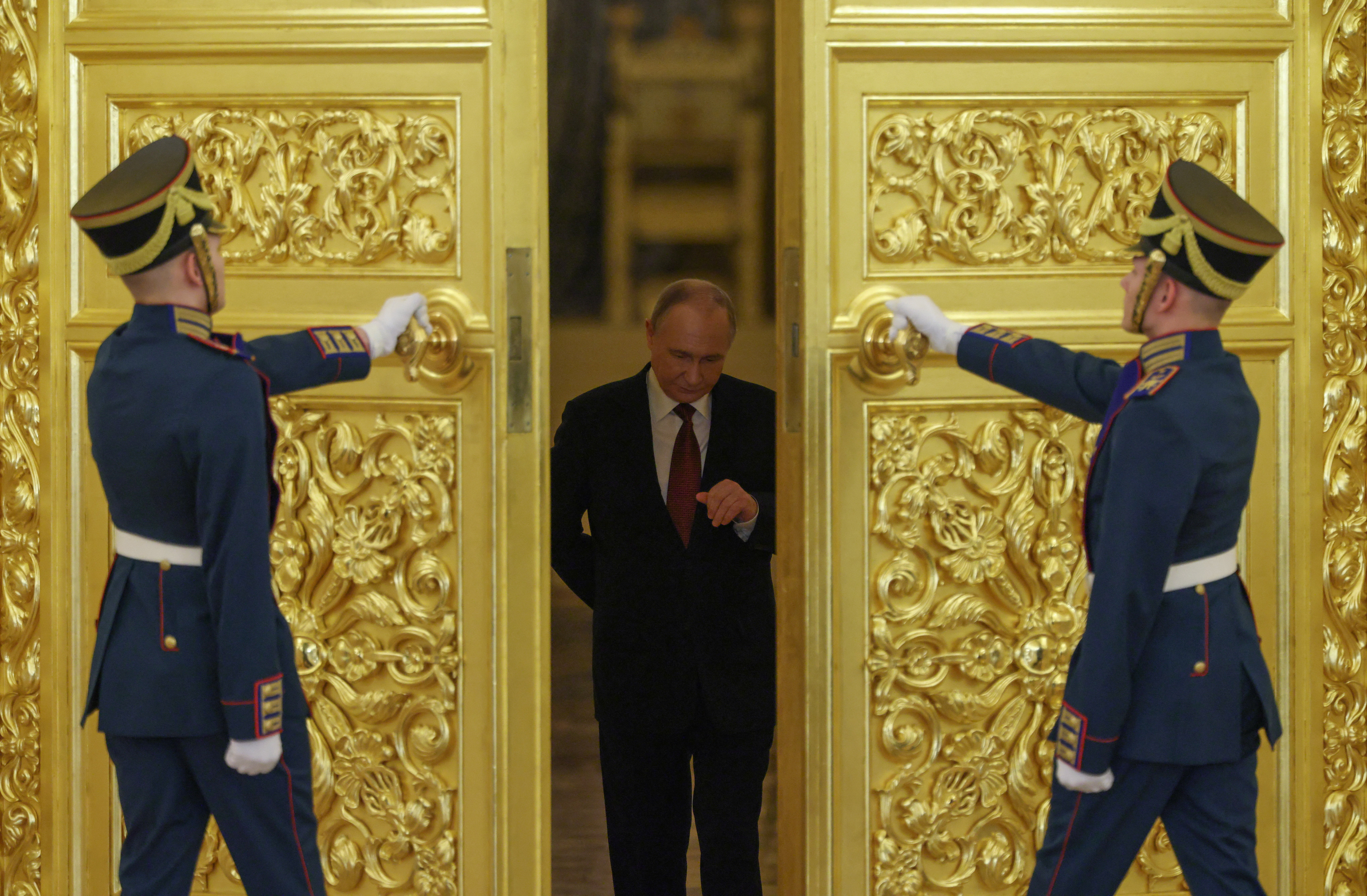 Russian President Vladimir Putin enters a hall during a ceremony to recei