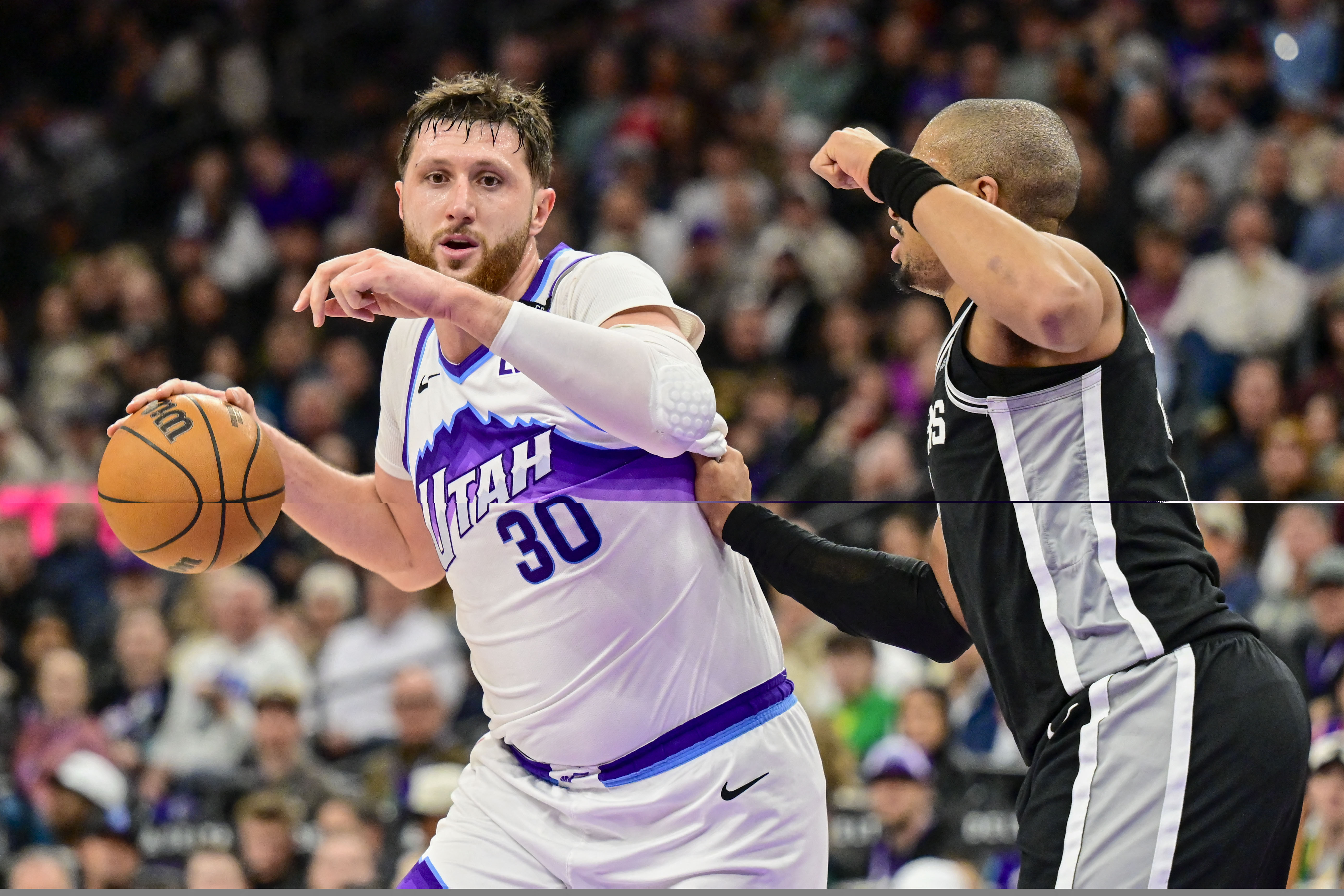 Jan 22, 2026; Salt Lake City, Utah, USA; Utah Jazz center Jusuf Nurkić (30) drives toward the basket against San Antonio Spurs forward/guard Keldon Johnson (3) during the second half at Delta Center. Mandatory Credit: Peter Creveling-Imagn Images