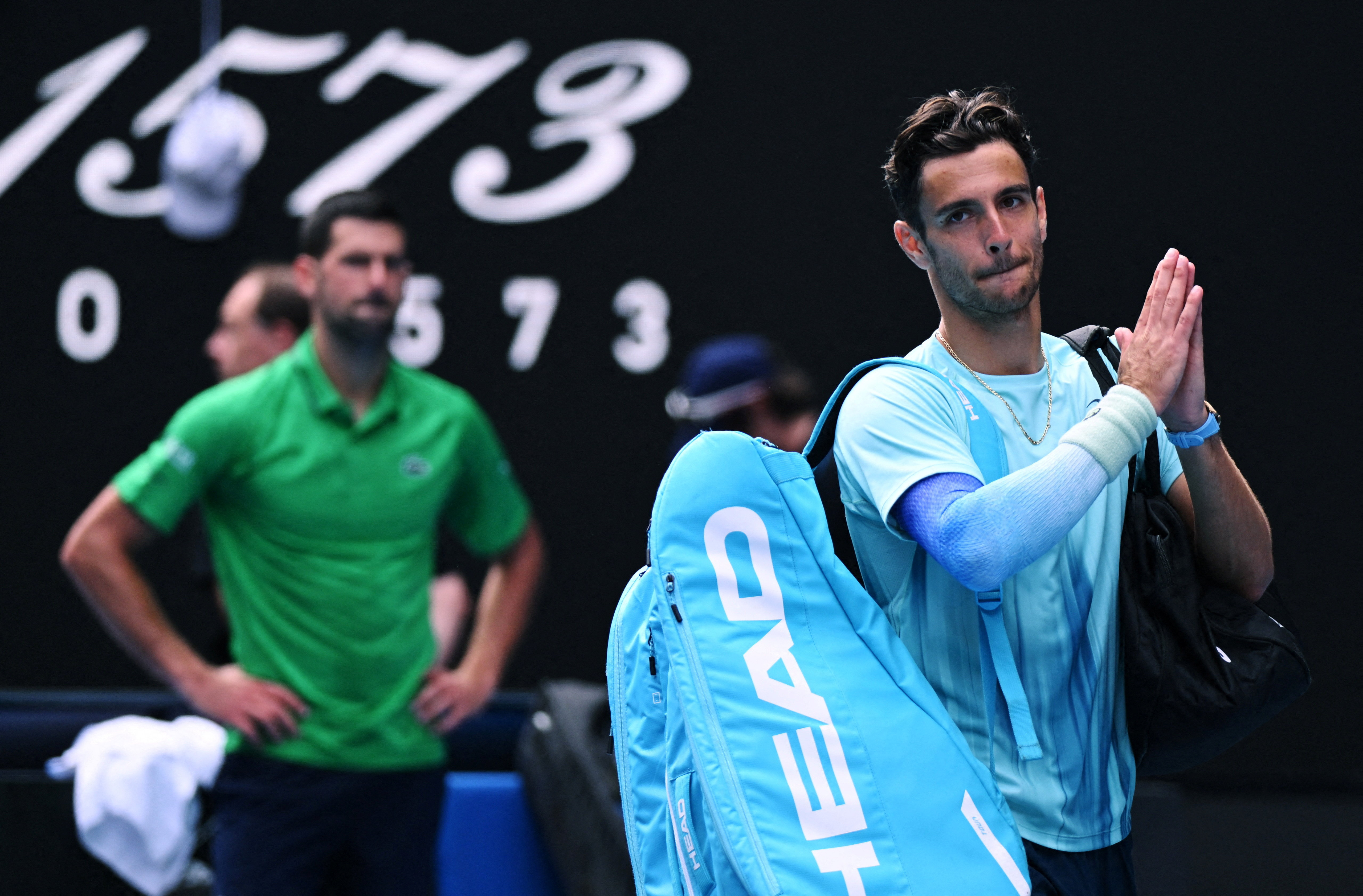 Tennis - Australian Open - Melbourne Park, Melbourne, Australia - January 28, 2026 Italy's Lorenzo Musetti applauds the fans and walks off the court after retiring from his quarter final match against Serbia's Novak Djokovic REUTERS/Jaimi Joy     TPX IMAG