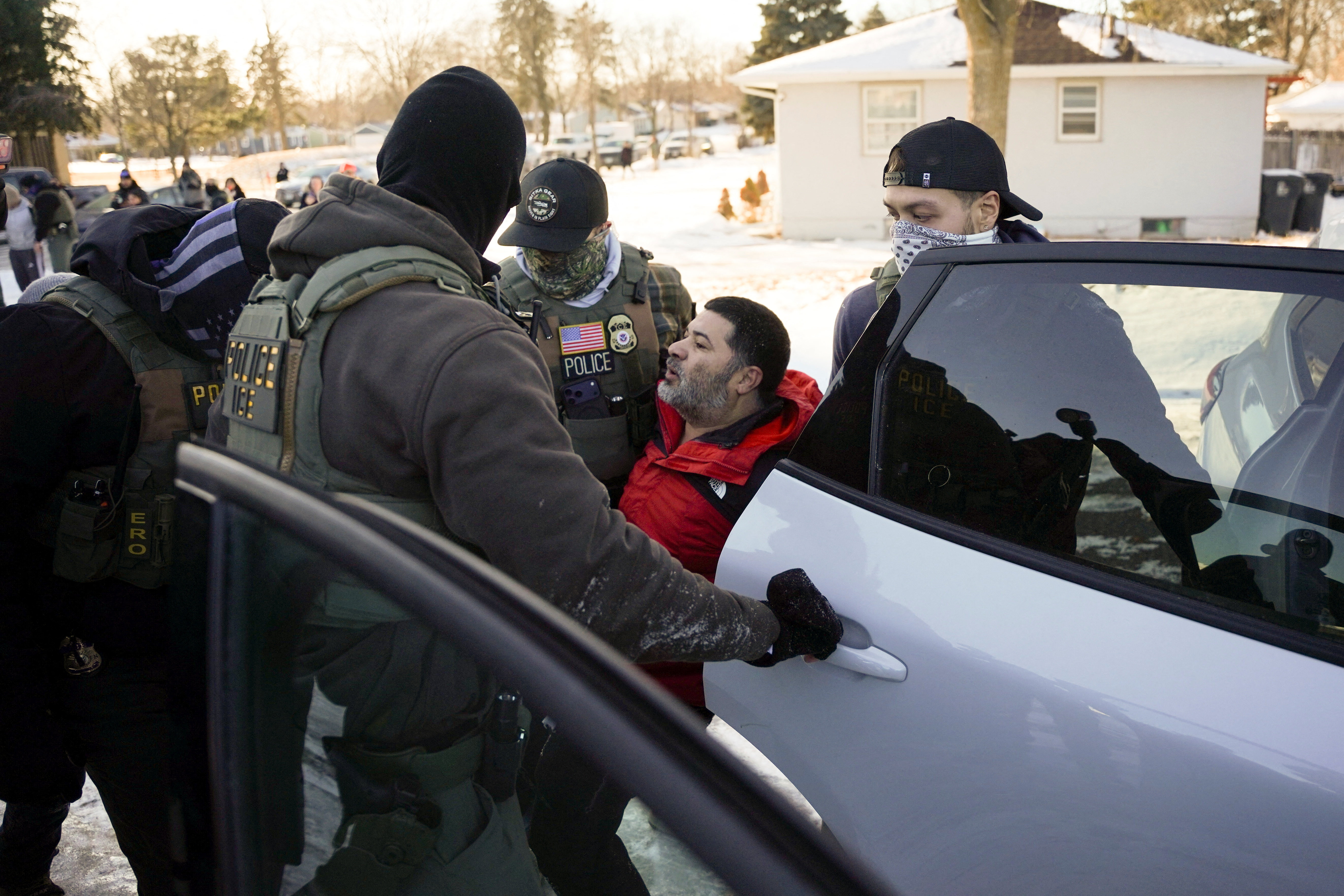 Federal agents detain a man as they conduct immigration enforcement action in Saint Paul, Minnesota, U.S., January 27, 2026. REUTERS/Seth Herald