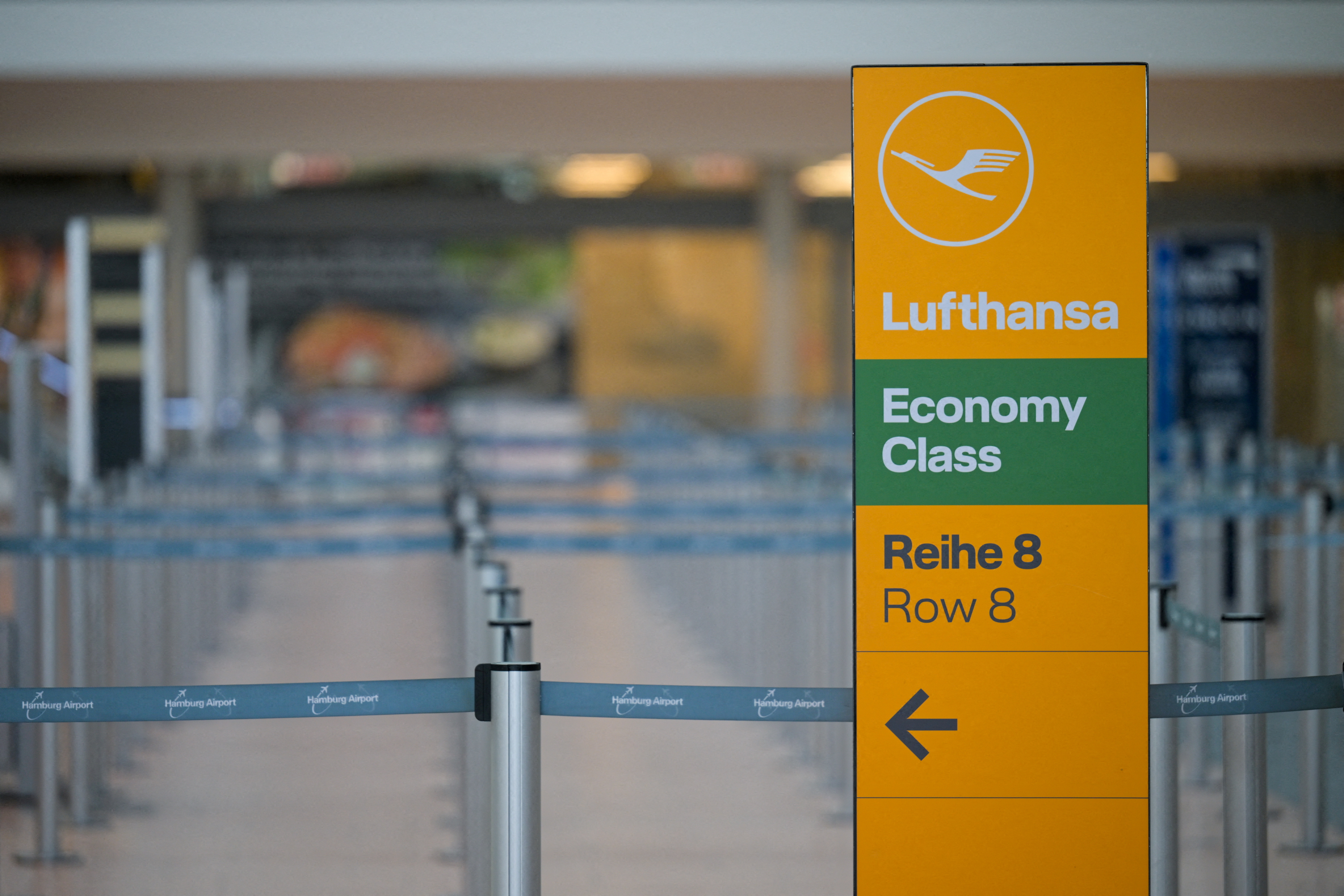 FILE PHOTO: A sign with a logo of Lufthansa stands at Hamburg airport in Hamburg, Germany March 9, 2025. REUTERS/Fabian Bimmer/File Photo