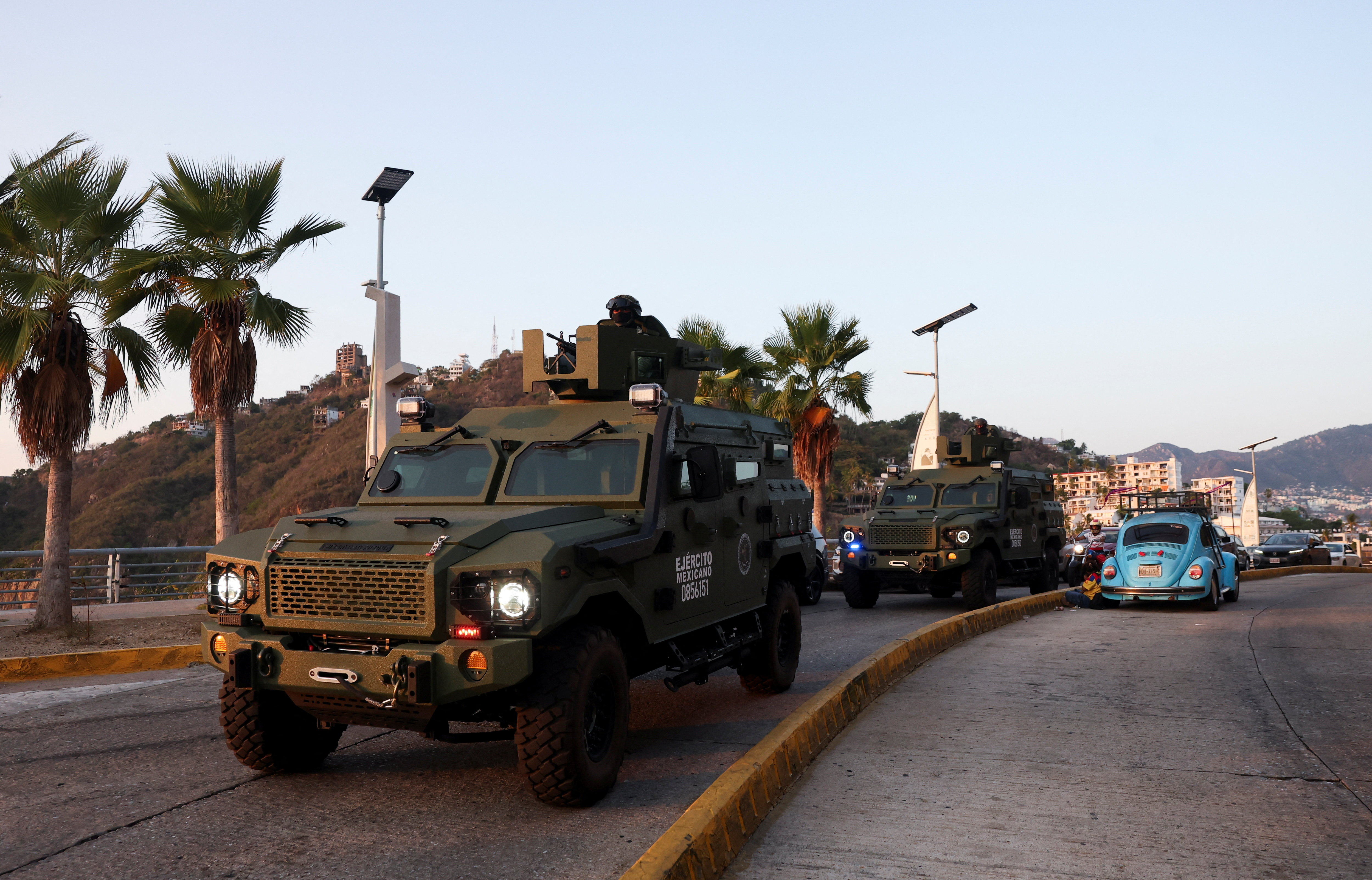 Mexican soldiers patrol in armored vehicles in Acapulco after authorities reinforced security following roadblocks and arson attacks carried out by organised crime in several states, in the aftermath of a military operation in which a government source sa