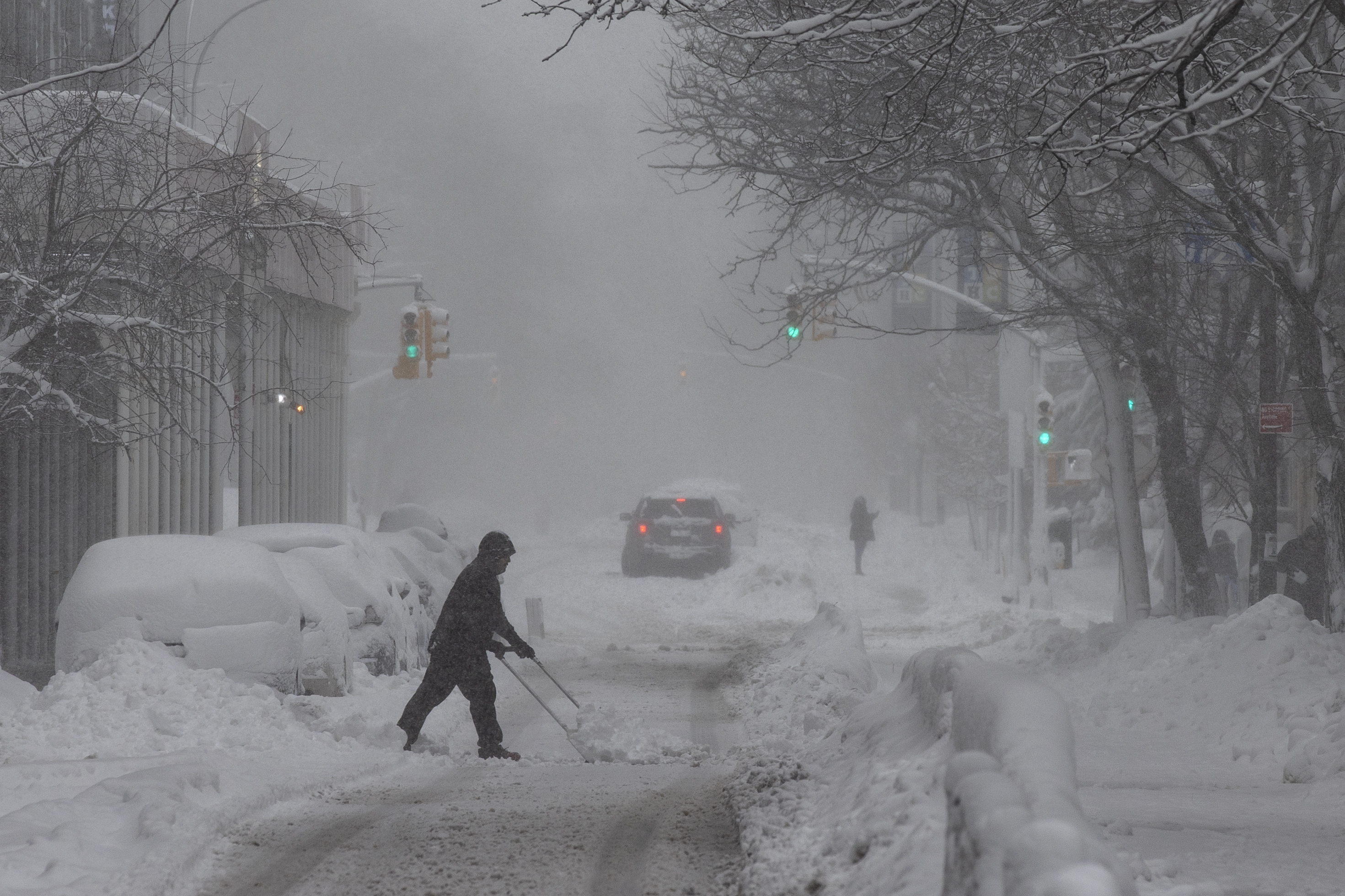 NEW YORK, NEW YORK - FEBRUARY 23: A person clears snow off the street during a blizzard in Brooklyn, New York, U.S., February 23, 2026. ( Mostafa Bassim - Anadolu Agency )