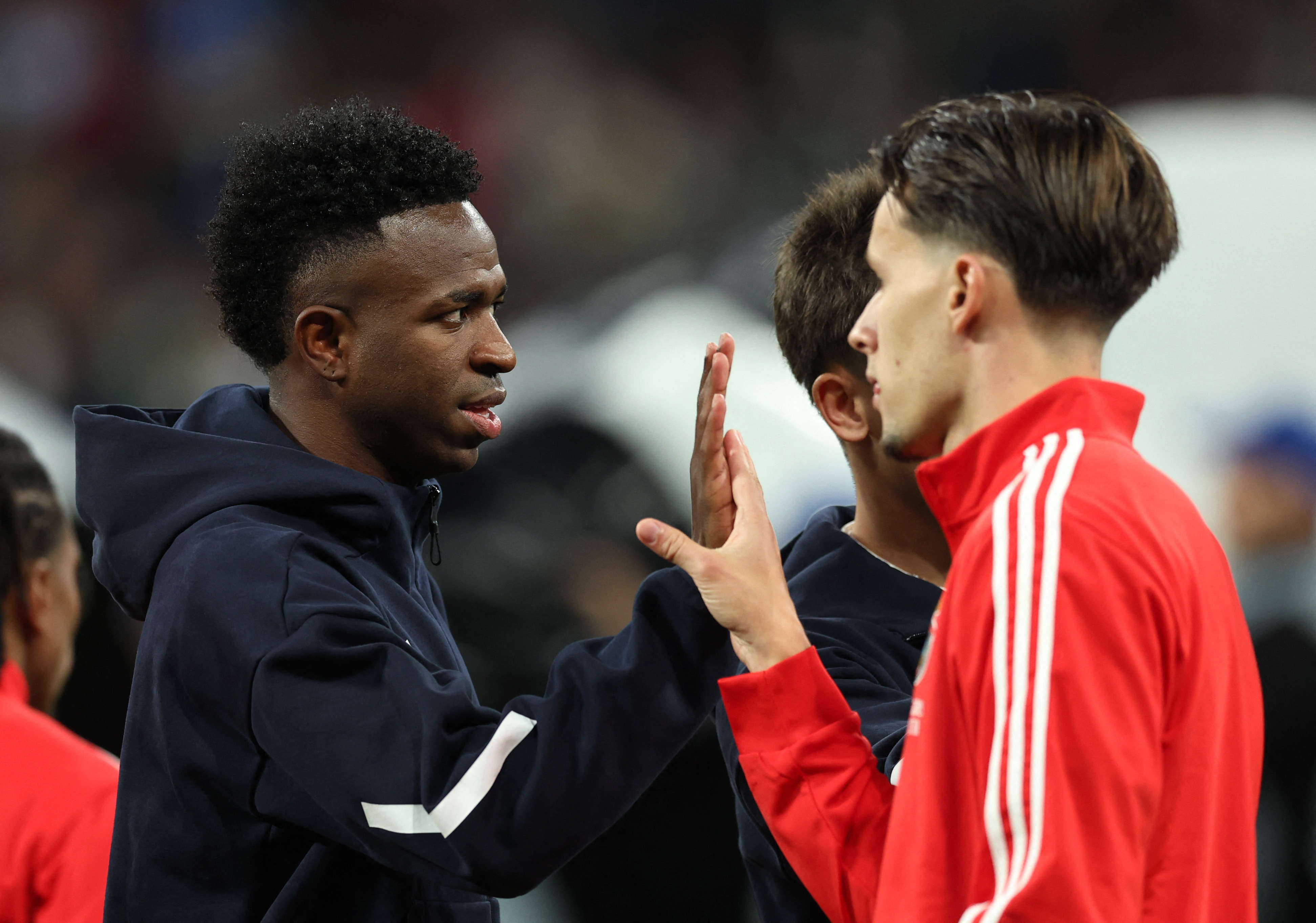 Soccer Football - UEFA Champions League - Play Off - Second Leg - Real Madrid v Benfica - Santiago Bernabeu, Madrid, Spain - February 25, 2026 Real Madrid's Vinicius Junior with Benfica's Amar Dedic before the match Dedić Amar