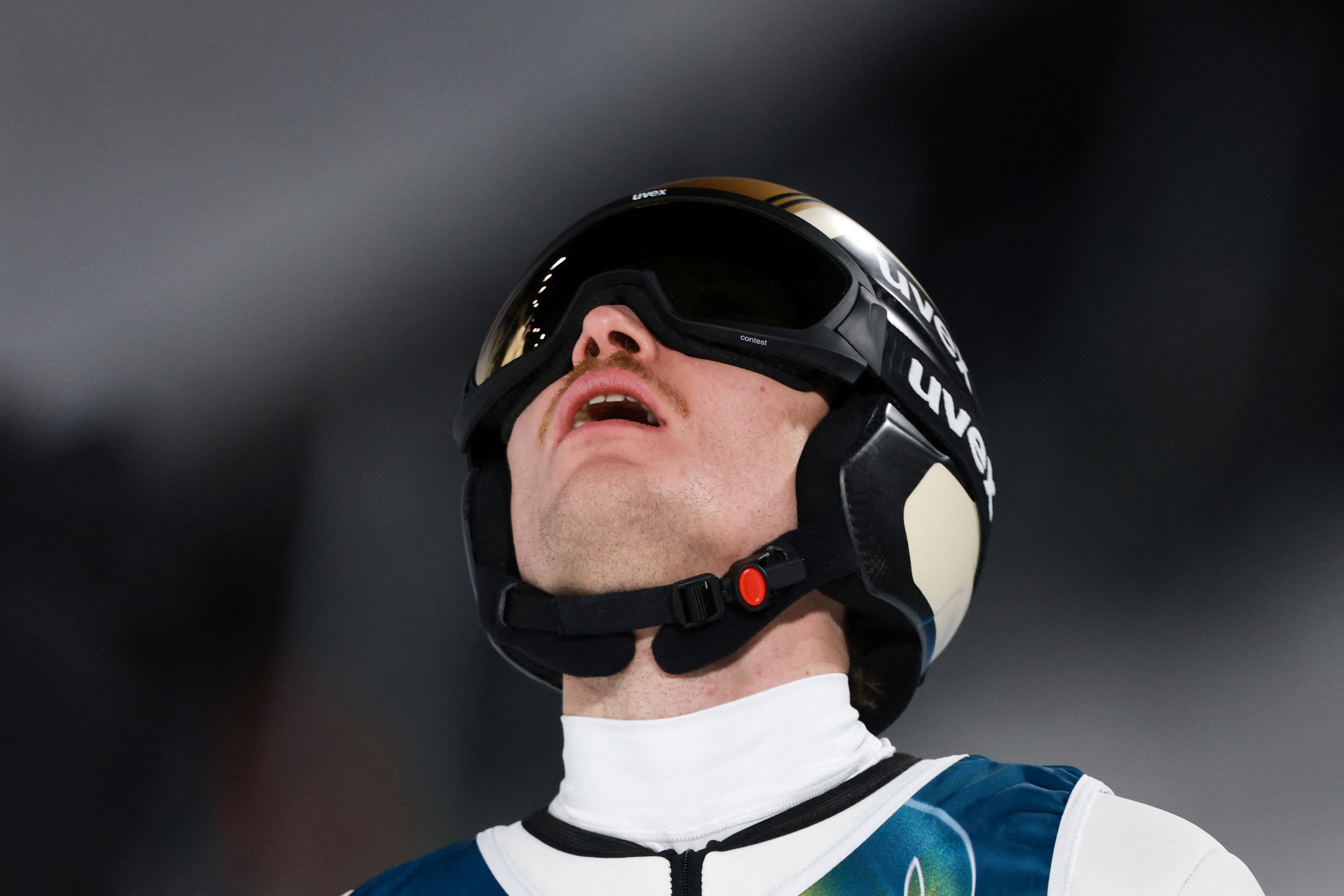 Milano Cortina 2026 Olympics - Ski Jumping - Men's Super Team - Predazzo Ski Jumping Stadium, Predazzo, Italy - February 16, 2026. Anze Lanisek of Slovenia reacts after the final round REUTERS/Stephanie Lecocq