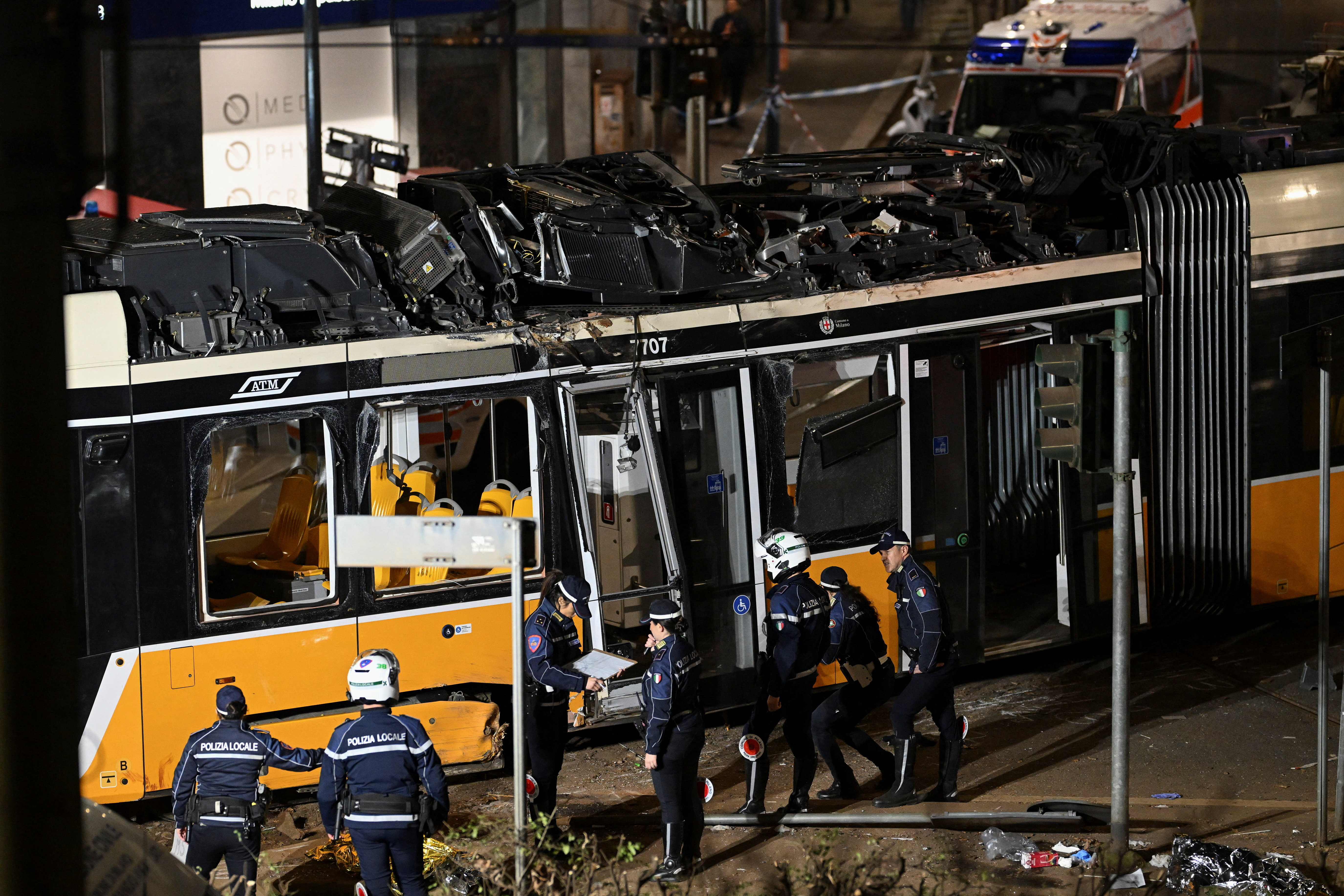 Emergency services work at the scene following a deadly tram derailment in Milan, Italy, February 27, 2026. REUTERS/Daniele Mascolo