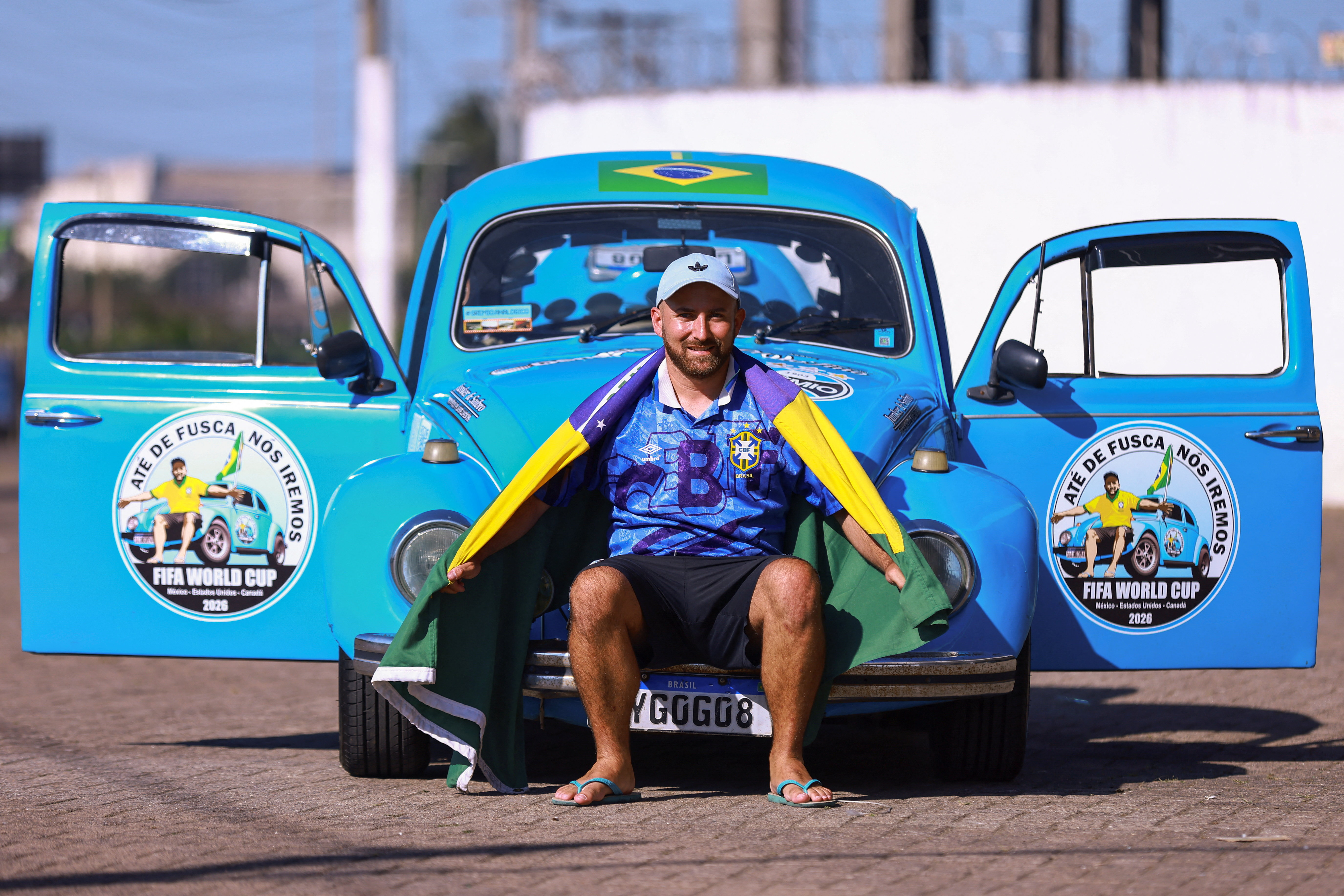 Brazilian Guilherme Martin poses with his 1971 Volkswagen Beetle in Porto Alegre,
