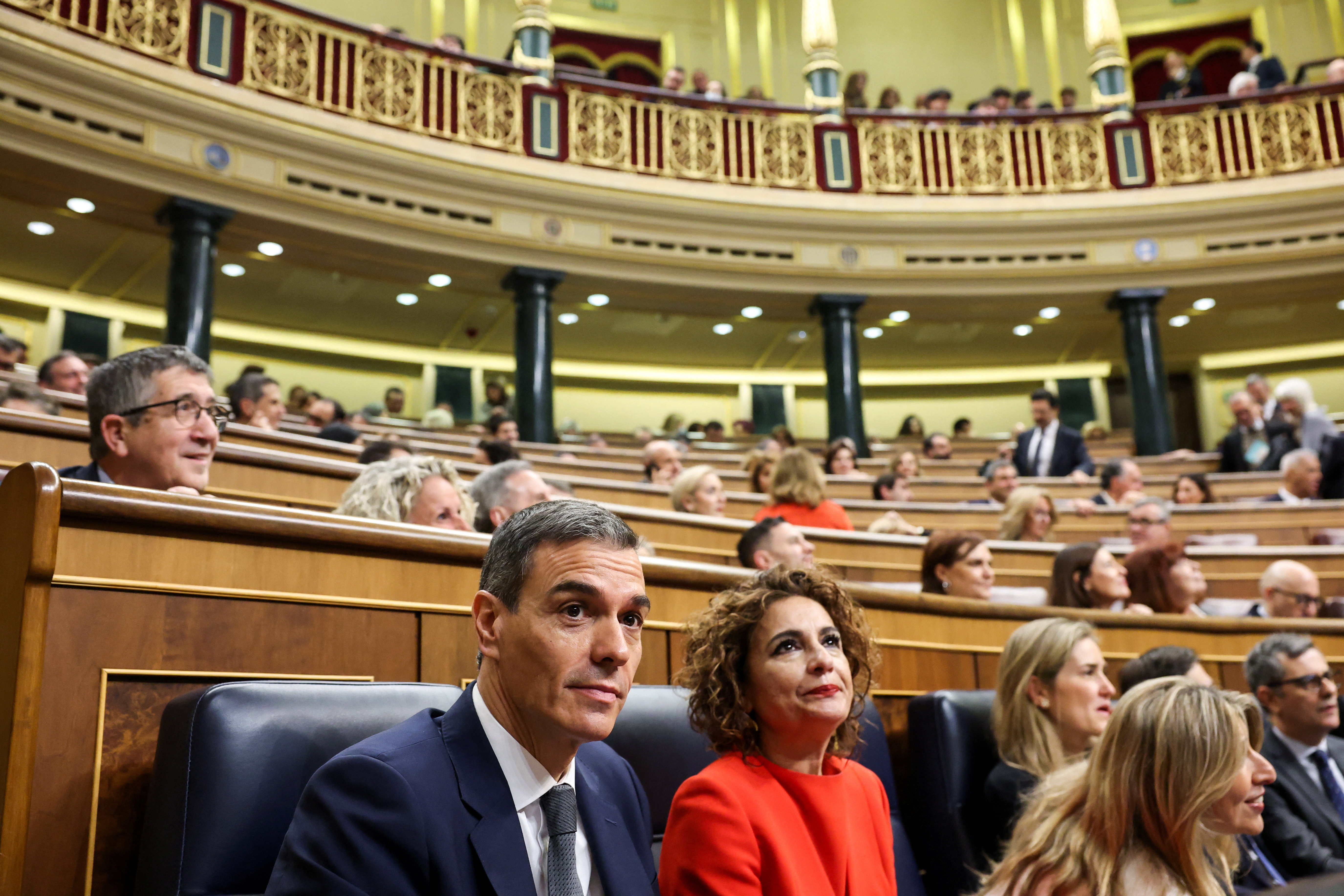 Spain's Prime Minister Pedro Sanchez sits next to First Deputy Prime Minister Maria Jesus Montero
