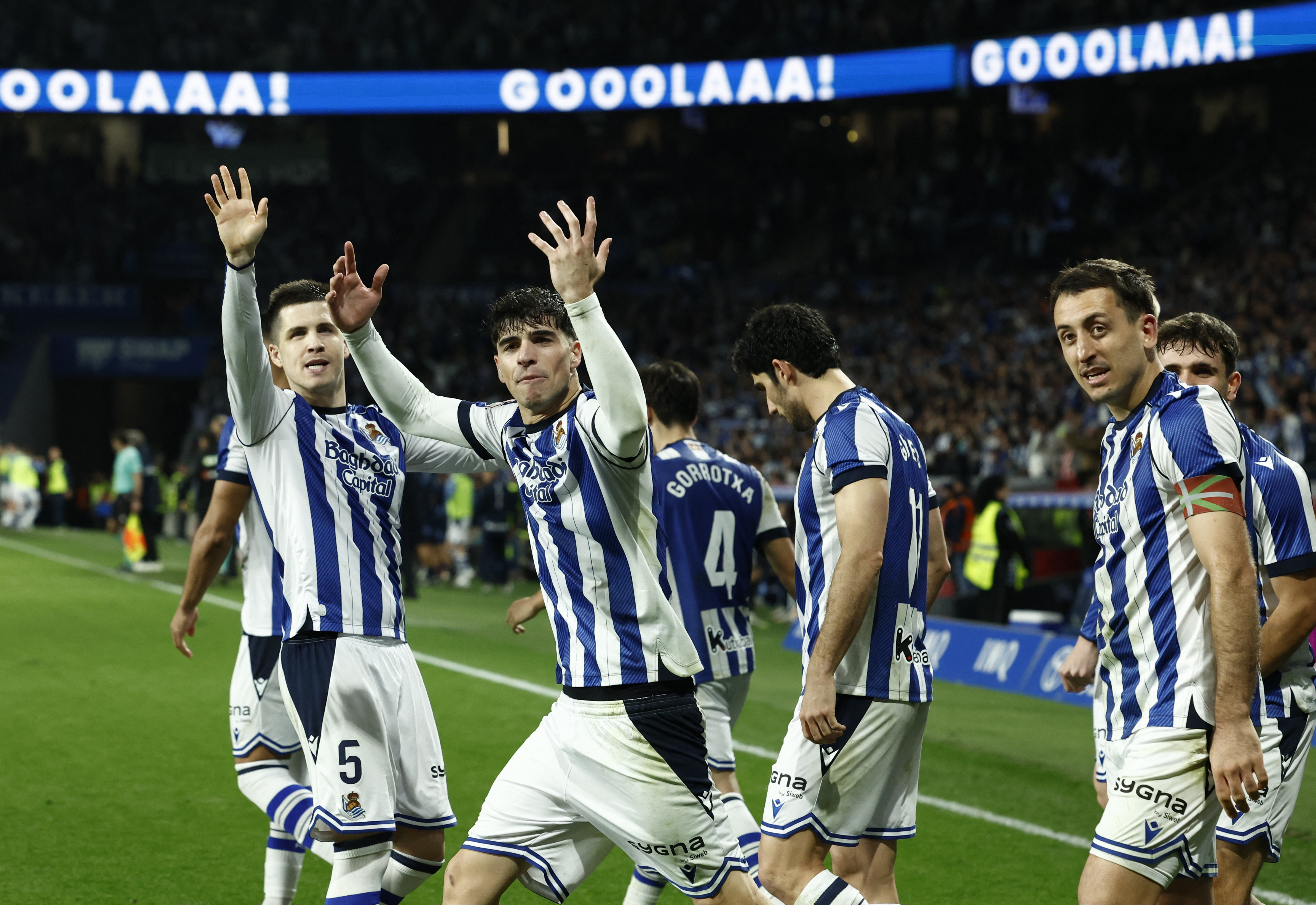 Soccer Football - Copa del Rey - Semi Final - Second Leg - Real Sociedad v Athletic Bilbao - Reale Arena, San Sebastian, Spain - March 4, 2026 Real Sociedad's Mikel Oyarzabal celebrates scoring their first goal with Igor Zubeldia and Pablo Marin REUTERS/V