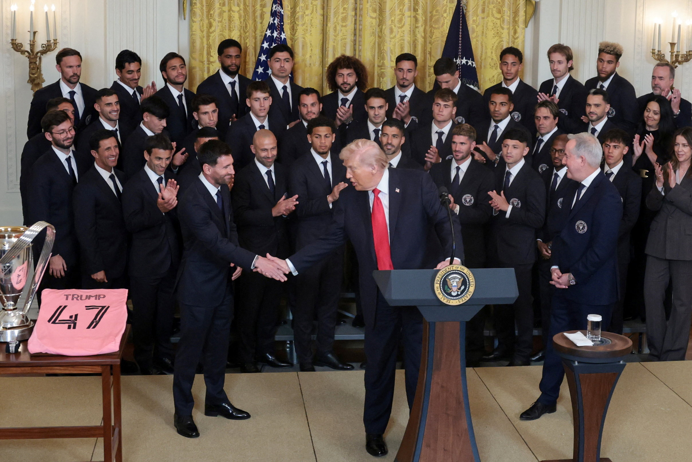 U.S. President Donald Trump shakes hands with Inter Miami CF captain Lionel Messi as he honors reigning Major League Soccer (MLS) champion Inter Miami CF players and team officials with an event in the East Room of the White House in Washington, D.C., U.S