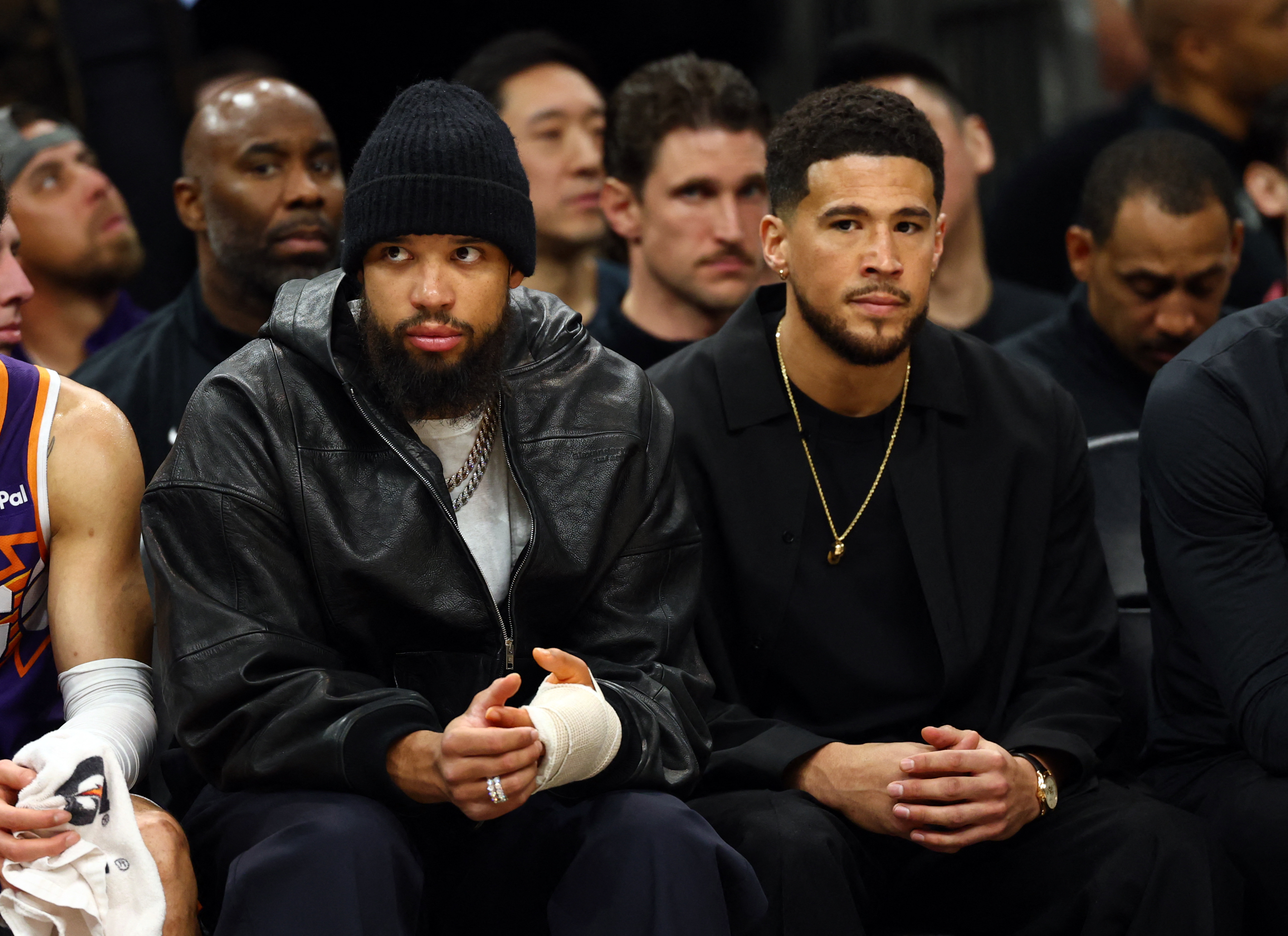 Feb 26, 2026; Phoenix, Arizona, USA; Injured Phoenix Suns forward Dillon Brooks (left) and guard Devin Booker on the bench against the Los Angeles Lakers in the first half at Mortgage Matchup Center. Mandatory Credit: Mark J. Rebilas-Imagn Images