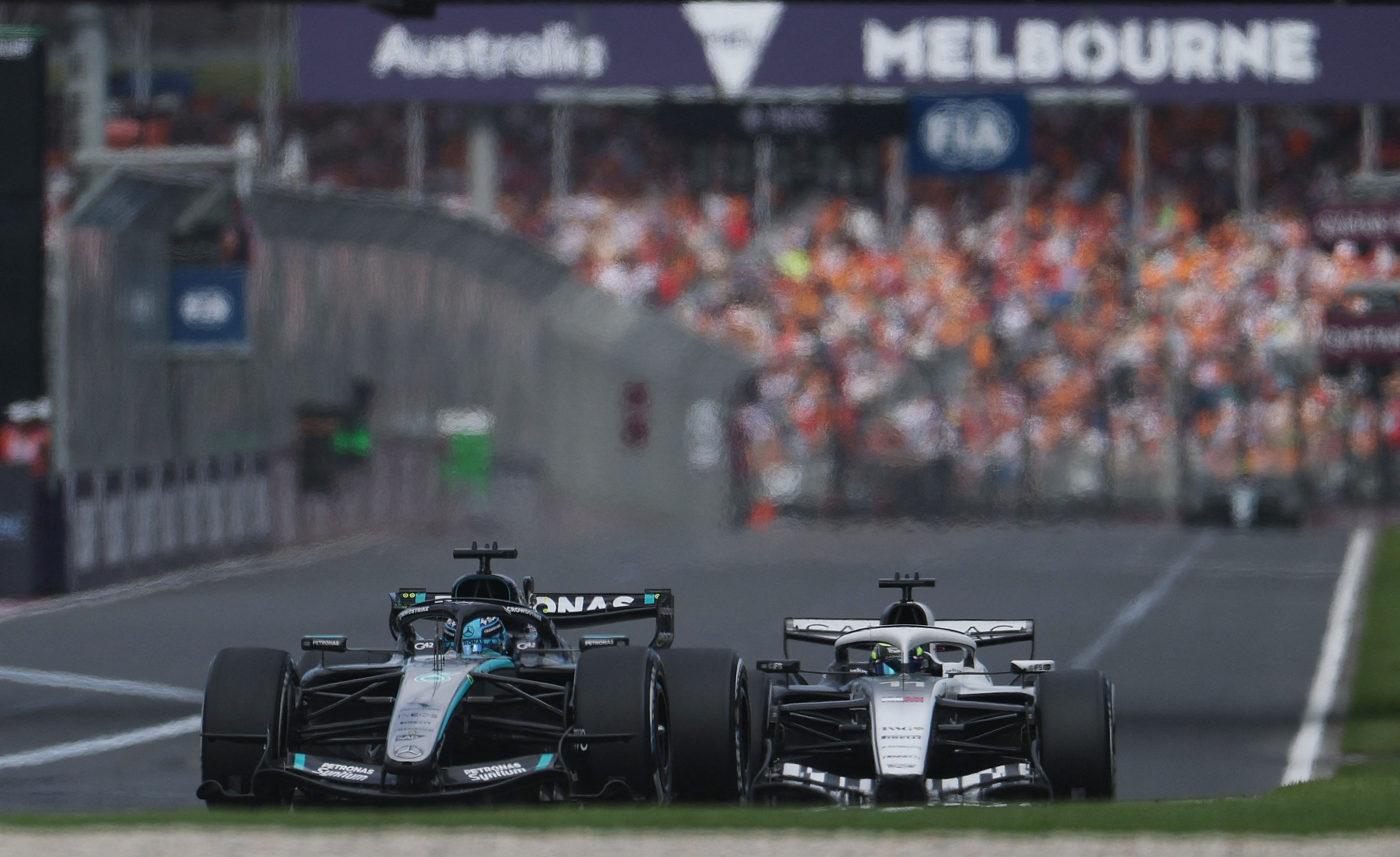 Formula One F1 - Australian Grand Prix - Albert Park Grand Prix Circuit, Melbourne, Australia - March 8, 2026 Mercedes' George Russell and Cadillac's Sergio Perez in action during the race REUTERS/Hollie Adams