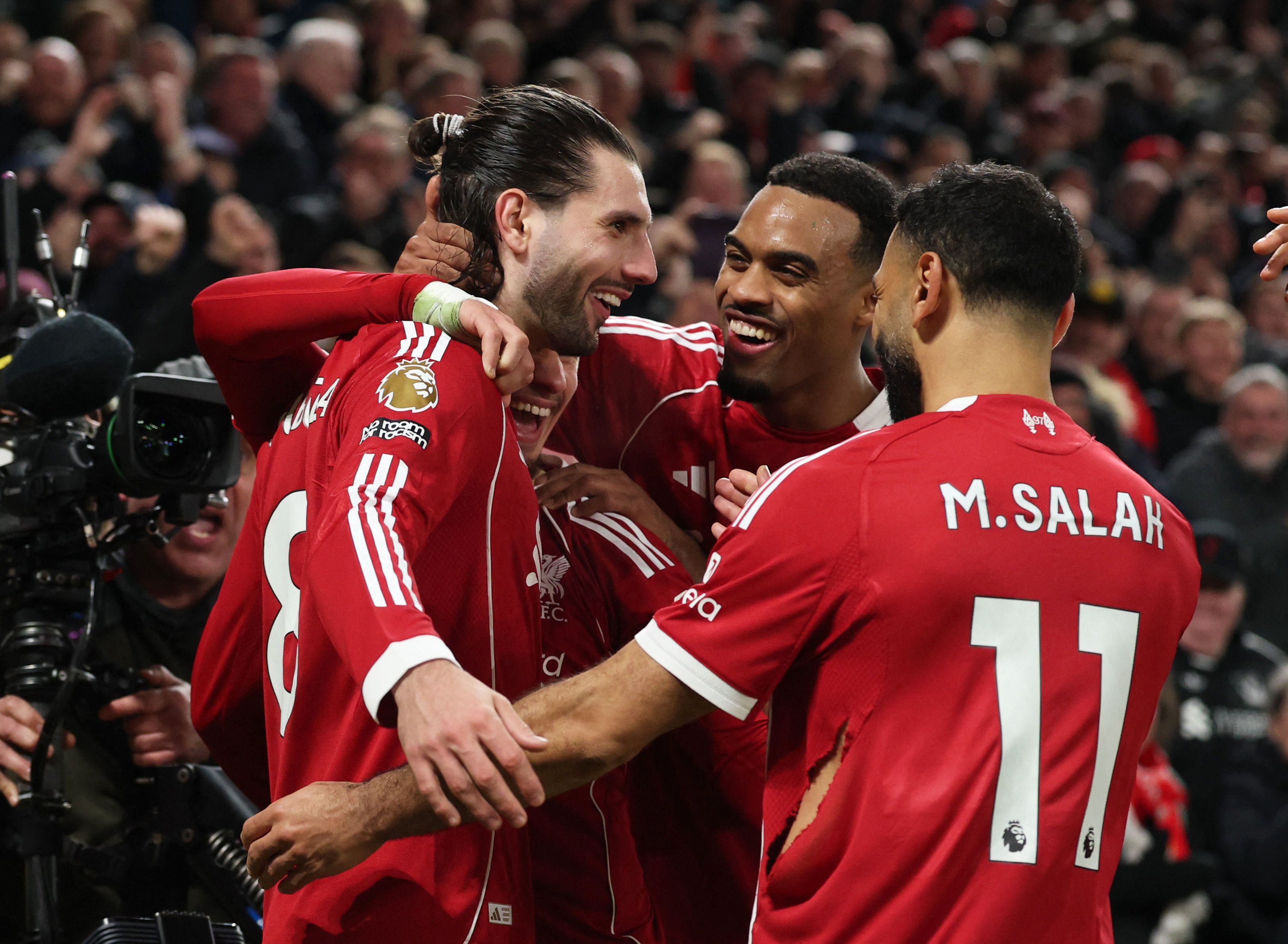 Soccer Football - Premier League - Liverpool v Manchester City - Anfield, Liverpool, Britain - February 8, 2026 Liverpool's Dominik Szoboszlai celebrates scoring their first goal with Ryan Gravenberch and Mohamed Salah REUTERS/Phil Noble EDITORIAL USE ONL