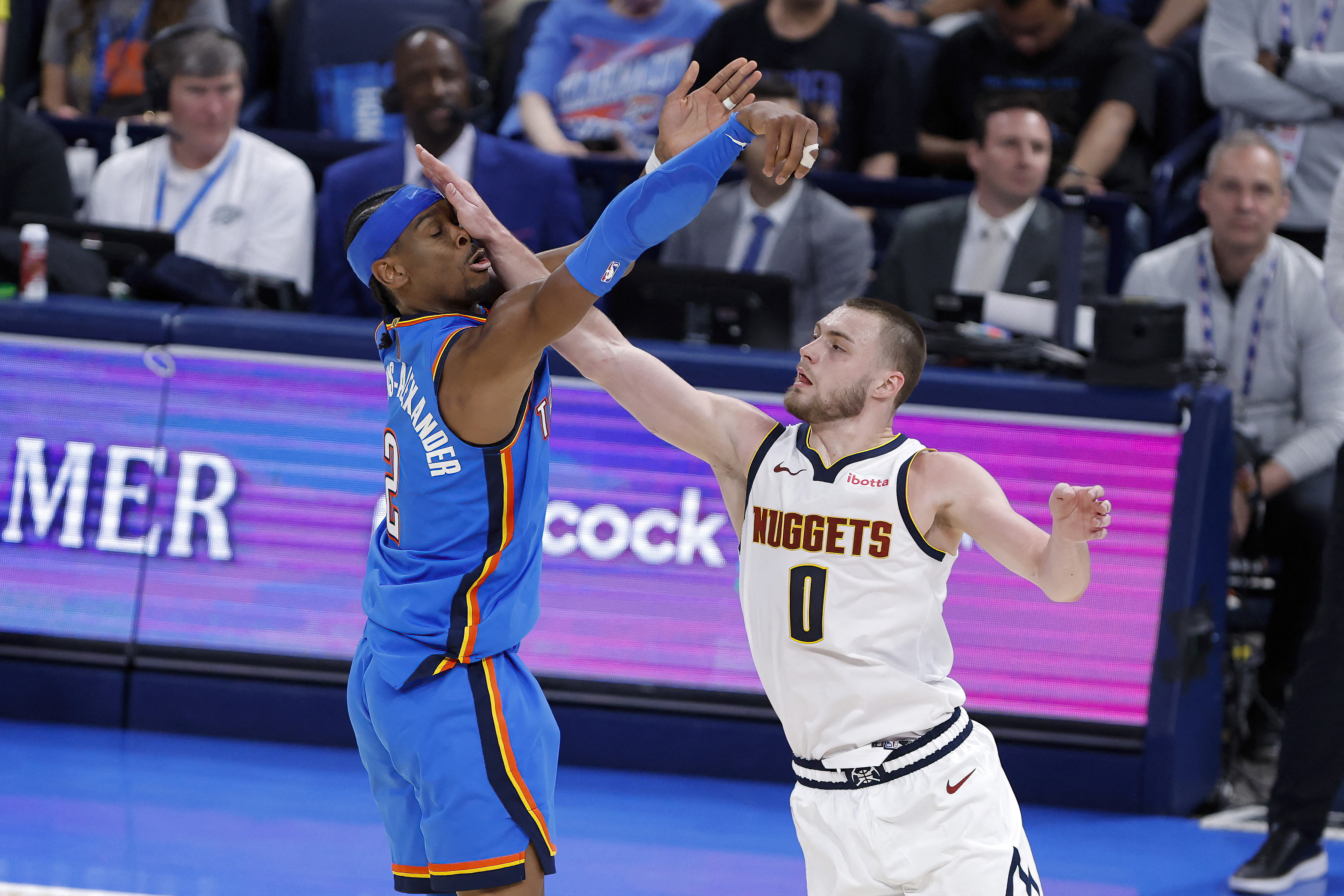 Mar 9, 2026; Oklahoma City, Oklahoma, USA; Oklahoma City Thunder guard Shai Gilgeous-Alexander (2) is hit in the face by Denver Nuggets guard Christian Braun (0) after shooting during the second half at Paycom Center. Mandatory Credit: Alonzo Adams-Imagn