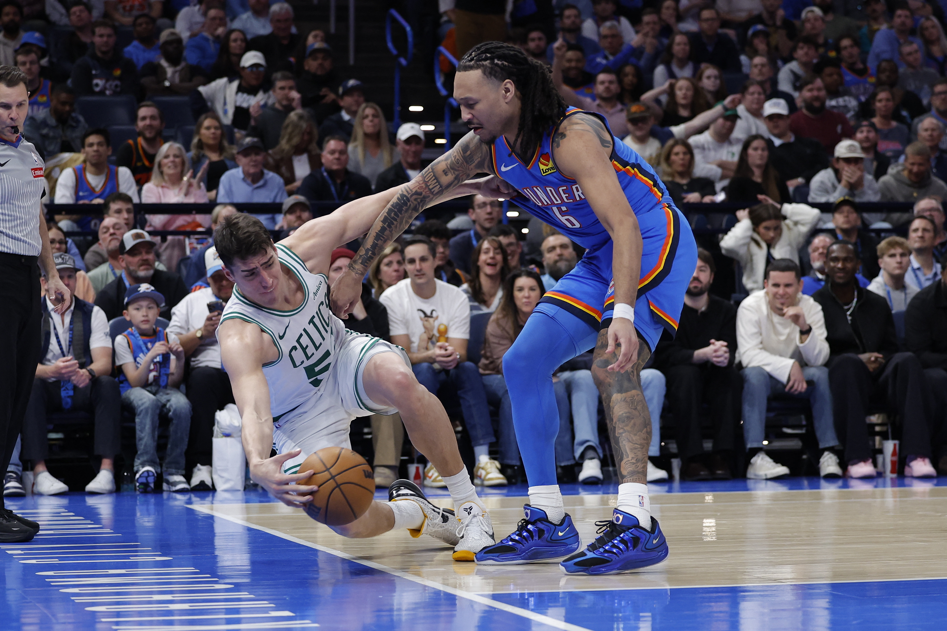 Mar 12, 2026; Oklahoma City, Oklahoma, USA; Boston Celtics center Luka Garza (52) and Oklahoma City Thunder forward Jaylin Williams (6) reach for a loose ball during the fourth quarter at Paycom Center. Mandatory Credit: Alonzo Adams-Imagn Images