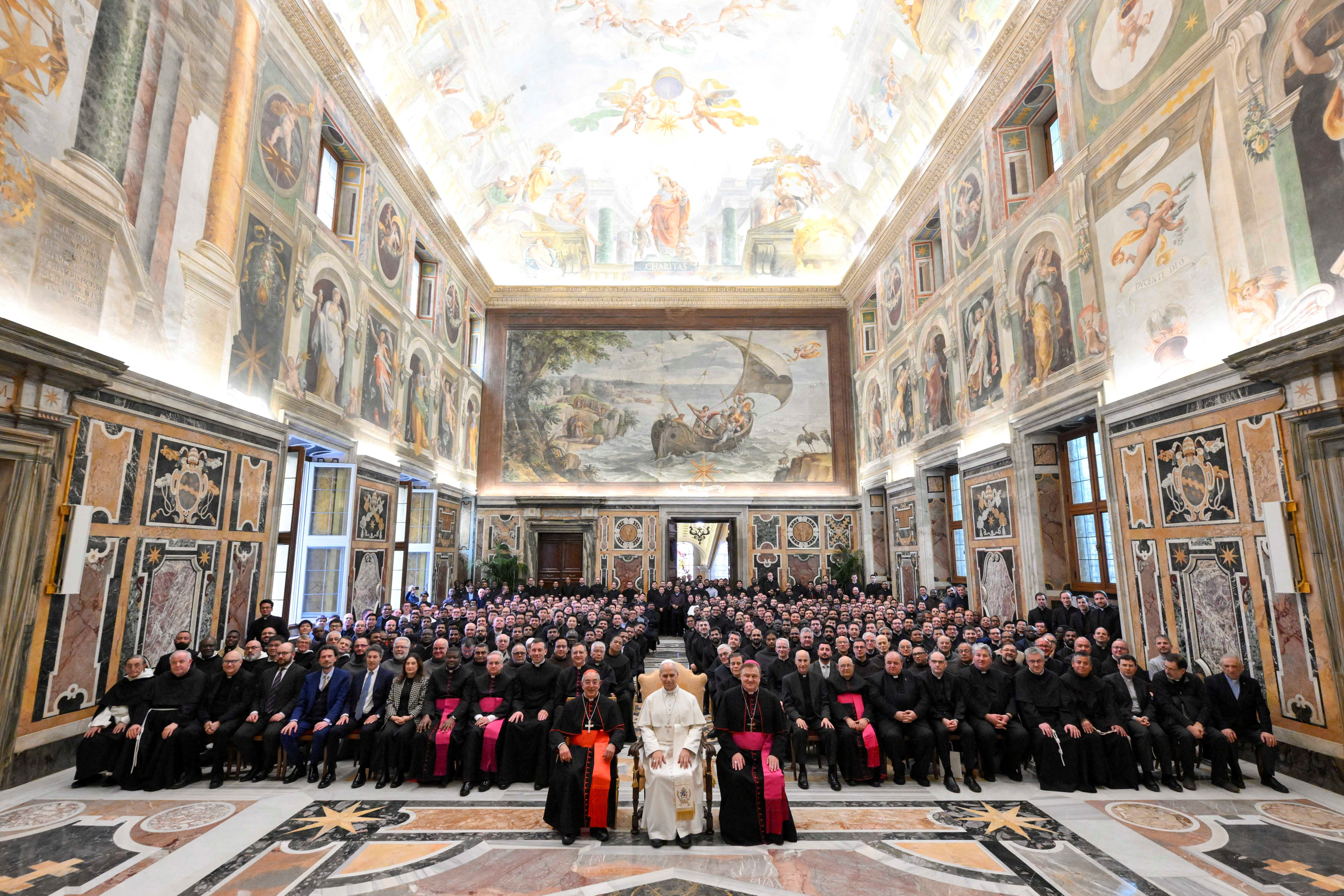 Pope Leo XIV poses for a group photo, on the day of the 36th