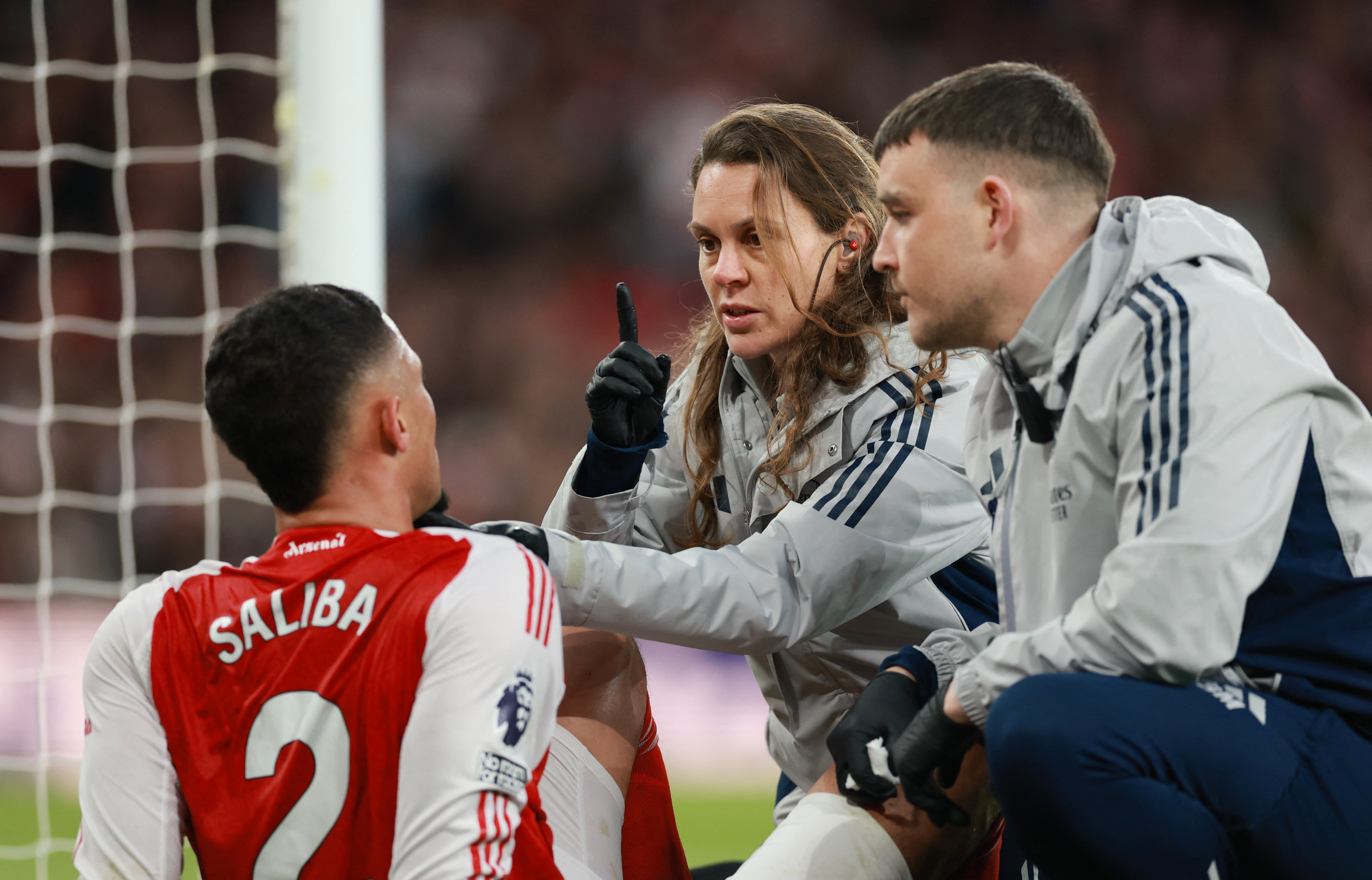 Soccer Football - Premier League - Arsenal v Everton - Emirates Stadium, London, Britain - March 14, 2026 Arsenal's William Saliba receives medical attention after sustaining an injury Action Images via Reuters/Paul Childs EDITORIAL USE ONLY. NO USE WITH