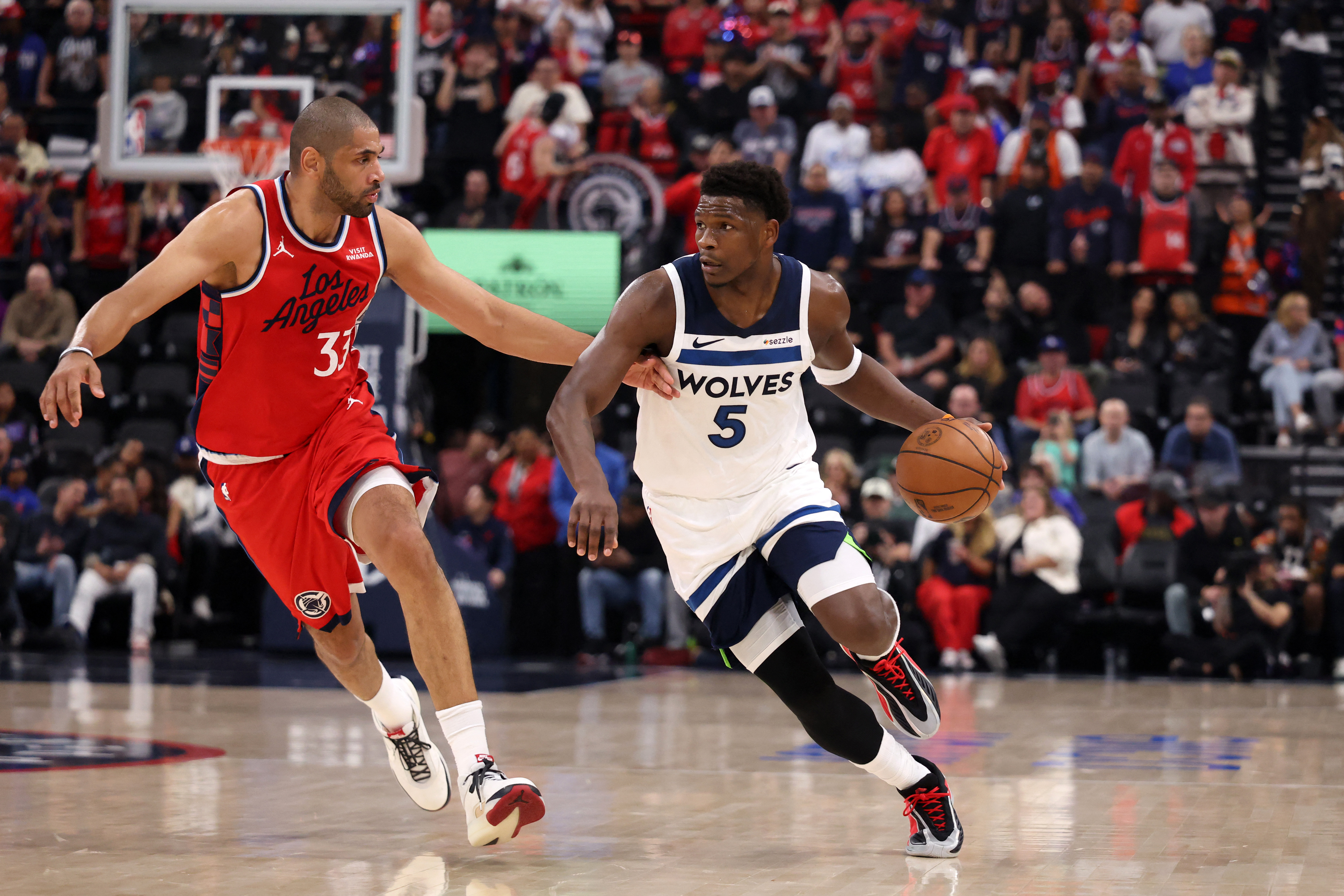 Feb 26, 2026; Inglewood, California, USA;   Minnesota Timberwolves guard Anthony Edwards (5) dribbles the ball against Los Angeles Clippers forward Nicolas Batum (33) during the first half at Intuit Dome. Mandatory Credit: Kiyoshi Mio-Imagn Images