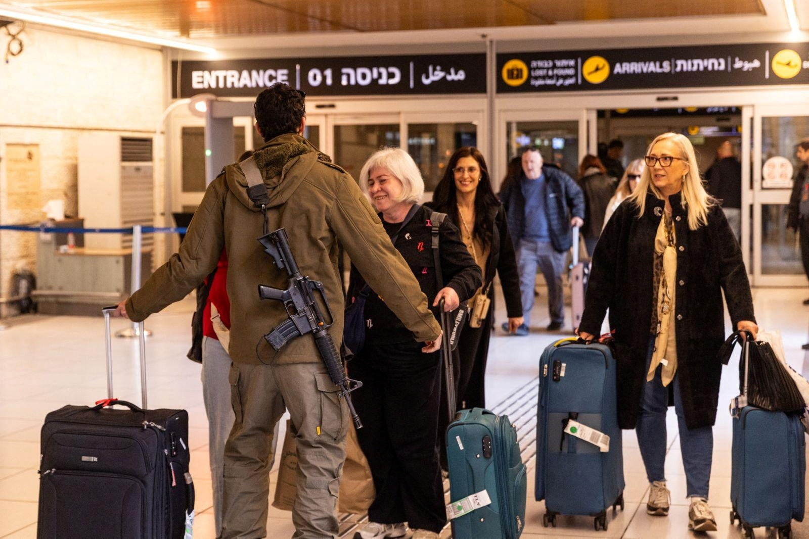 An Israeli soldier greets loved ones who returned to Israel from Italy