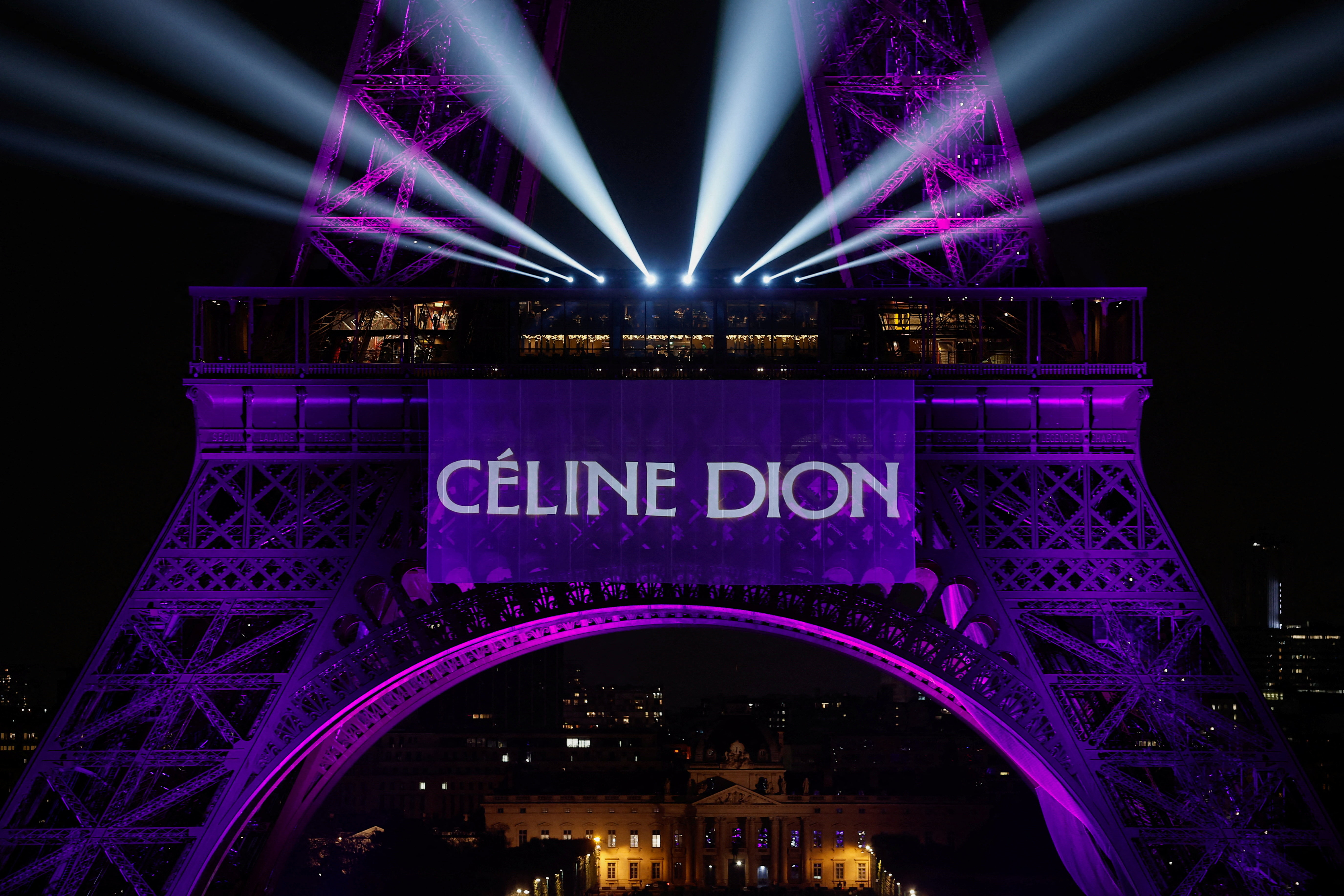 The Eiffel Tower lights up to mark the announcement of concert dates and ticket sales for singer Celine Dion's upcoming ten concerts in September and October in Paris, France, March 30, 2026. REUTERS/Benoit Tessier