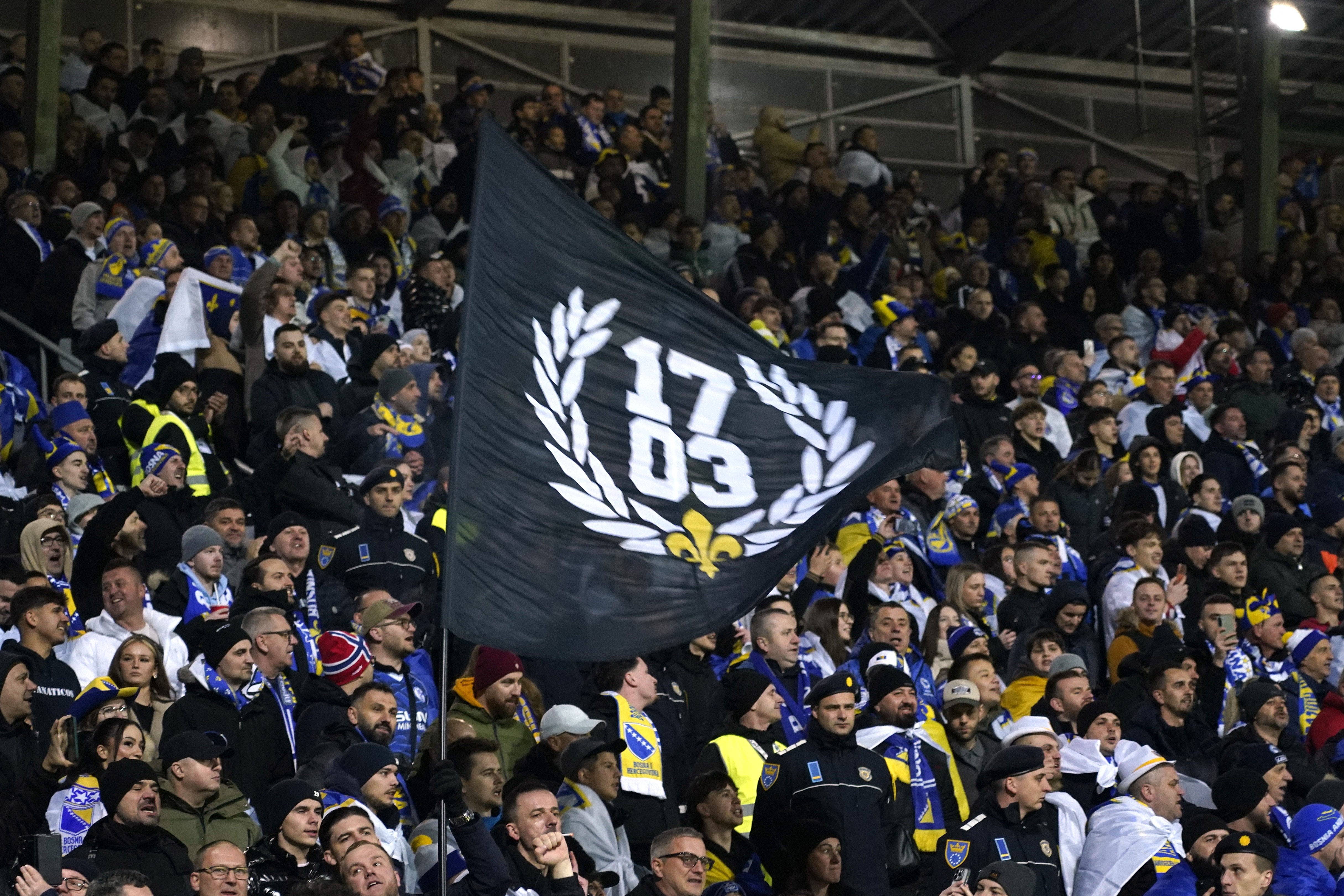 2026-03-Soccer Football - FIFA World Cup - UEFA Qualifiers - Finals - Bosnia and Herzegovina v Italy - Bilino Polje Stadium, Zenica, Bosnia and Herzegovina - March 31, 2026 Bosnia and Herzegovina fan with a flag inside the stadium-WORLDCUP-BIH-ITA (1).JPG