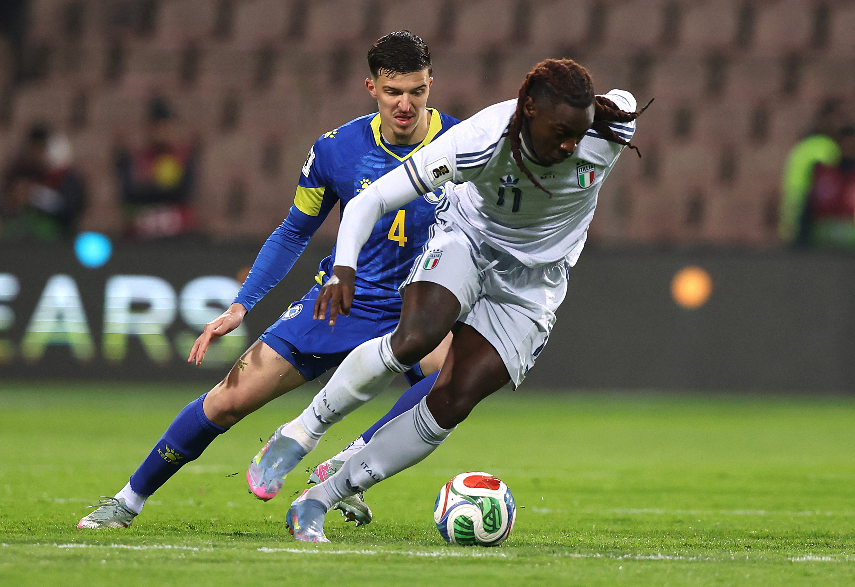Soccer Football - FIFA World Cup - UEFA Qualifiers - Finals - Bosnia and Herzegovina v Italy - Bilino Polje Stadium, Zenica, Bosnia and Herzegovina - March 31, 2026 Bosnia and Herzegovina's Tarik Muharemovic in action with Italy's Moise Kean REUTERS/Amel