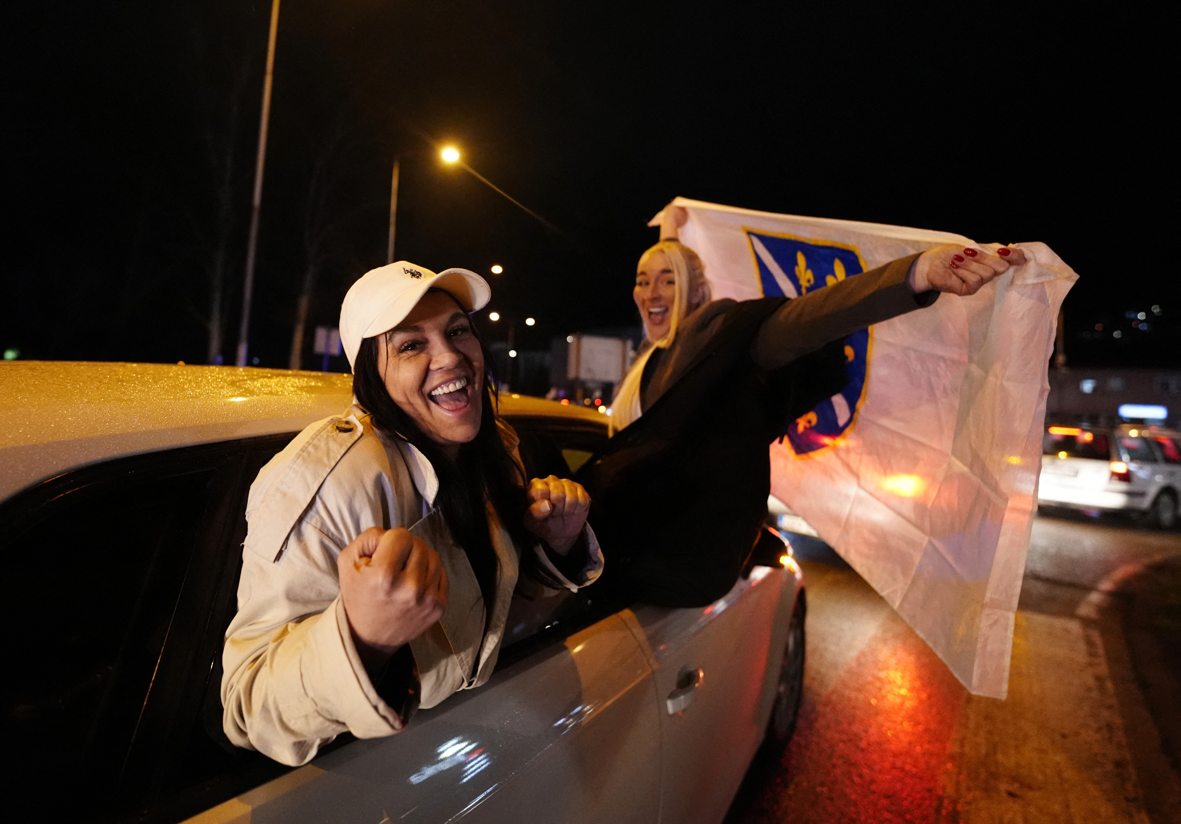 Soccer Football - FIFA World Cup - UEFA Qualifiers - Finals - Bosnia and Herzegovina v Italy - Zenica, Bosnia and Herzegovina - April 1, 2026 Bosnia and Herzegovina fans celebrate out of a car after qualifying for the FIFA World Cup outside the stadium RE