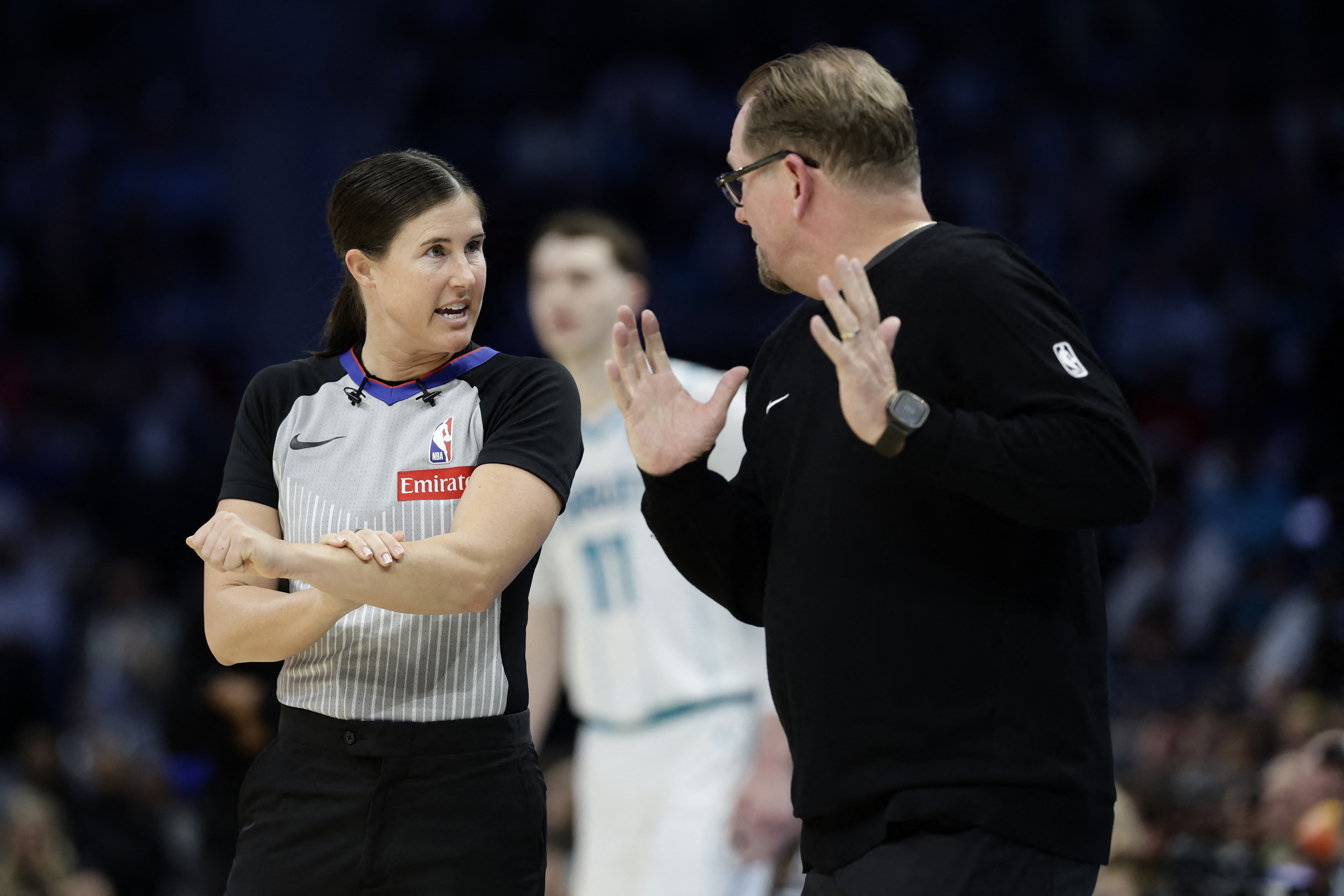 Mar 28, 2026; Charlotte, North Carolina, USA; Referee Natalie Sago (9) explains a foul call to Philadelphia 76ers Head Coach Nick Nurse during the fourth quarter against the Charlotte Hornets at Spectrum Center. Mandatory Credit: Brian Westerholt-Imagn Im