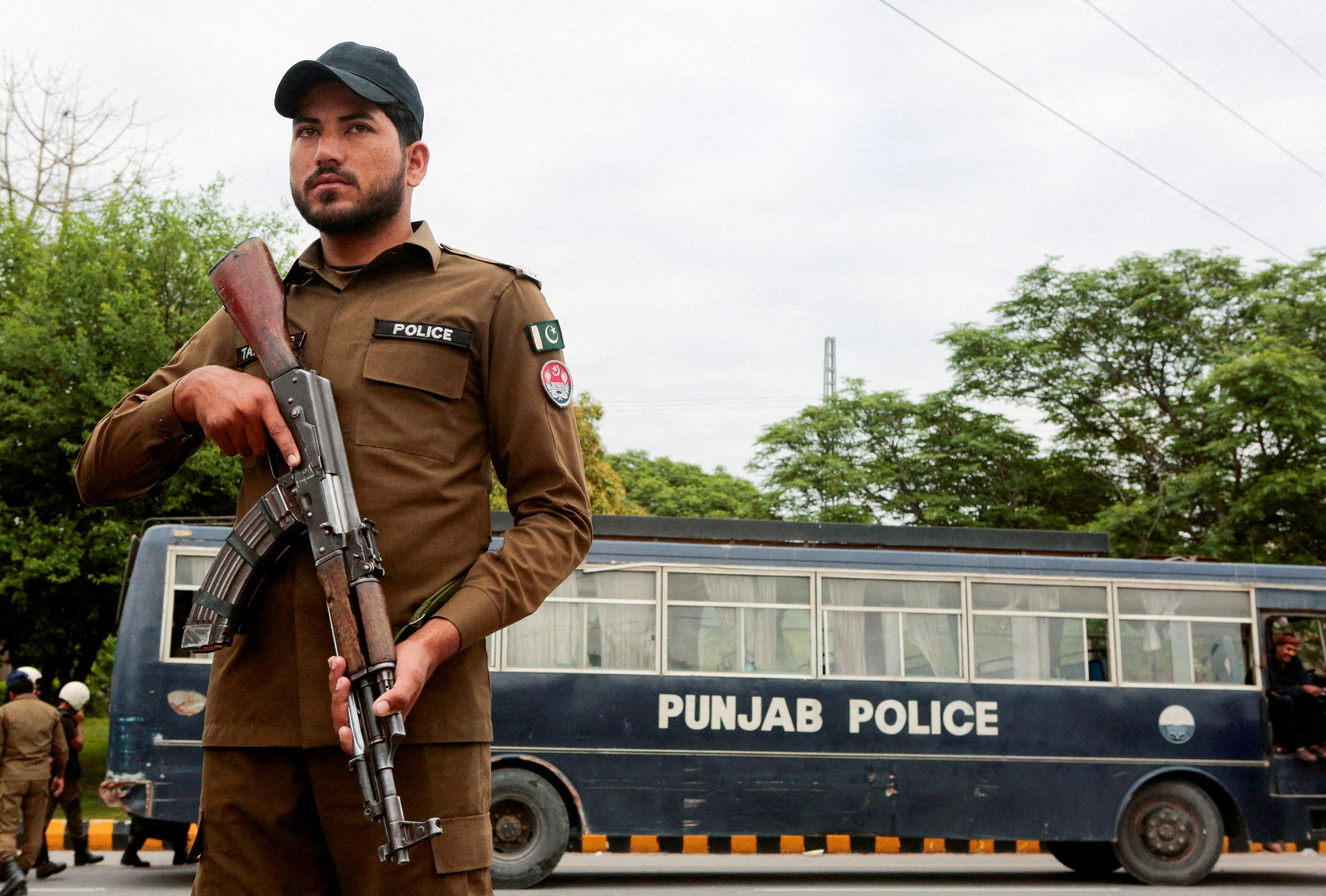 FILE PHOTO: A police officer stands guard on a road leading to