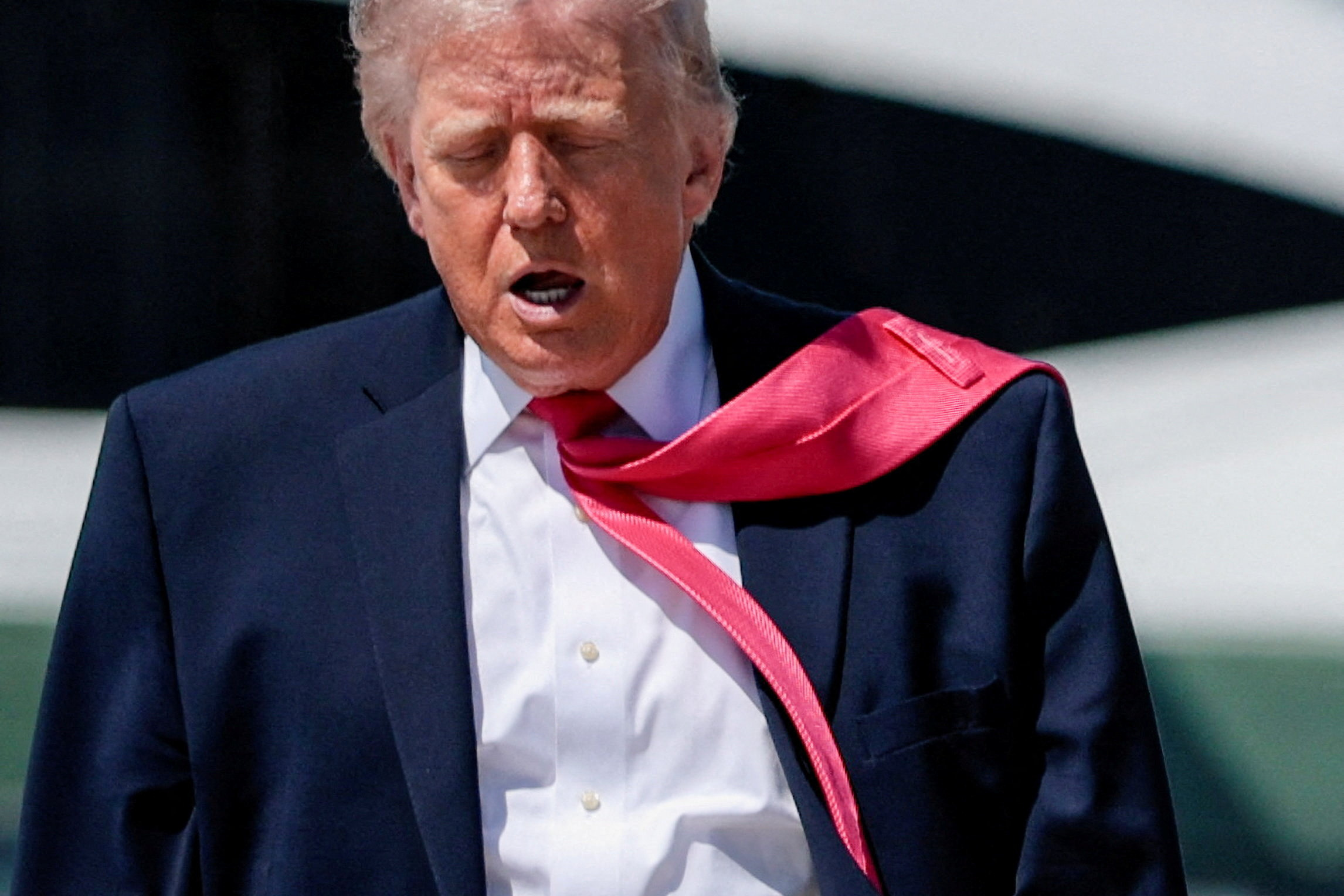 U.S. President Donald Trump's tie is blown by the wind