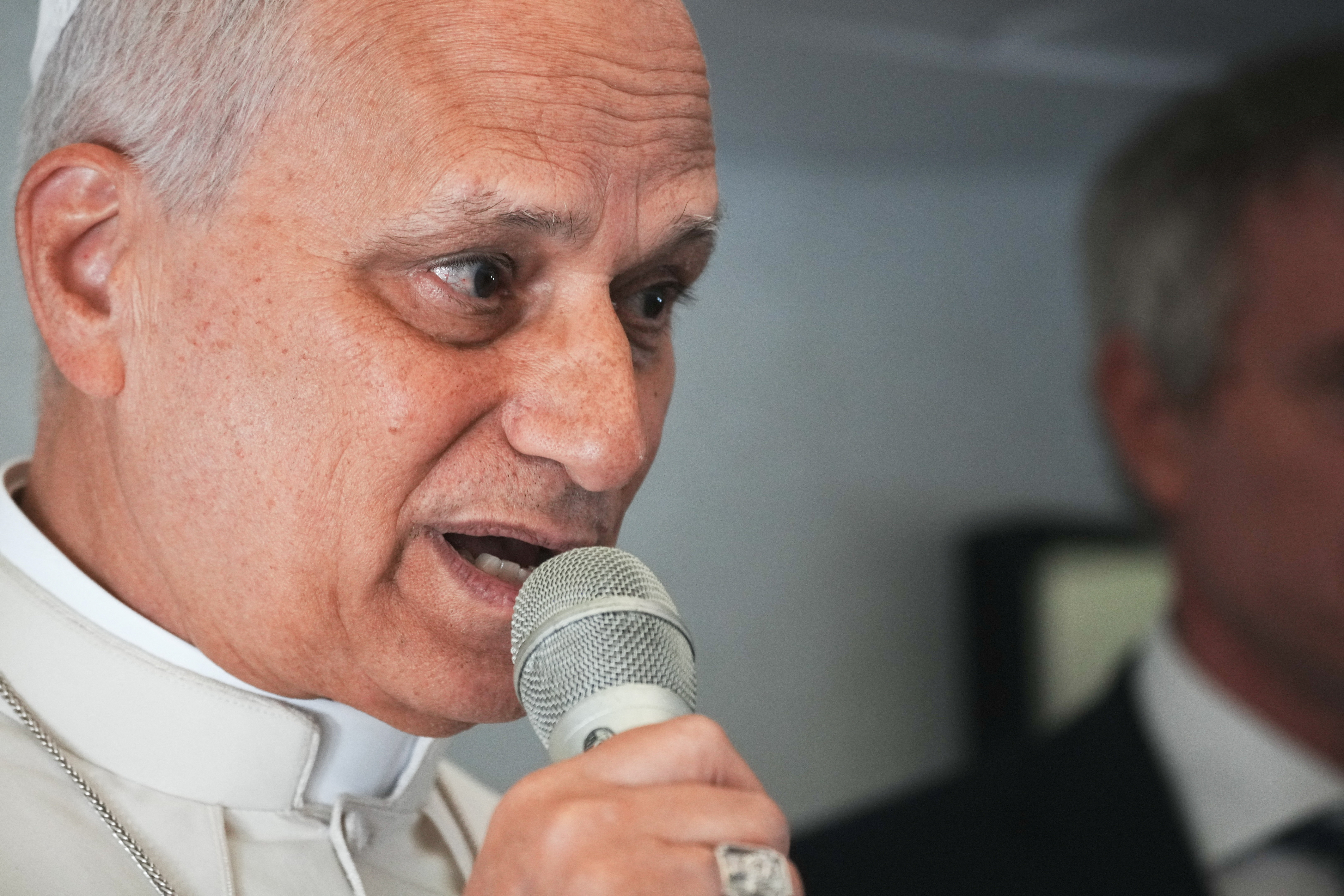 Pope Leo XIV speaks to journalists aboard the papal