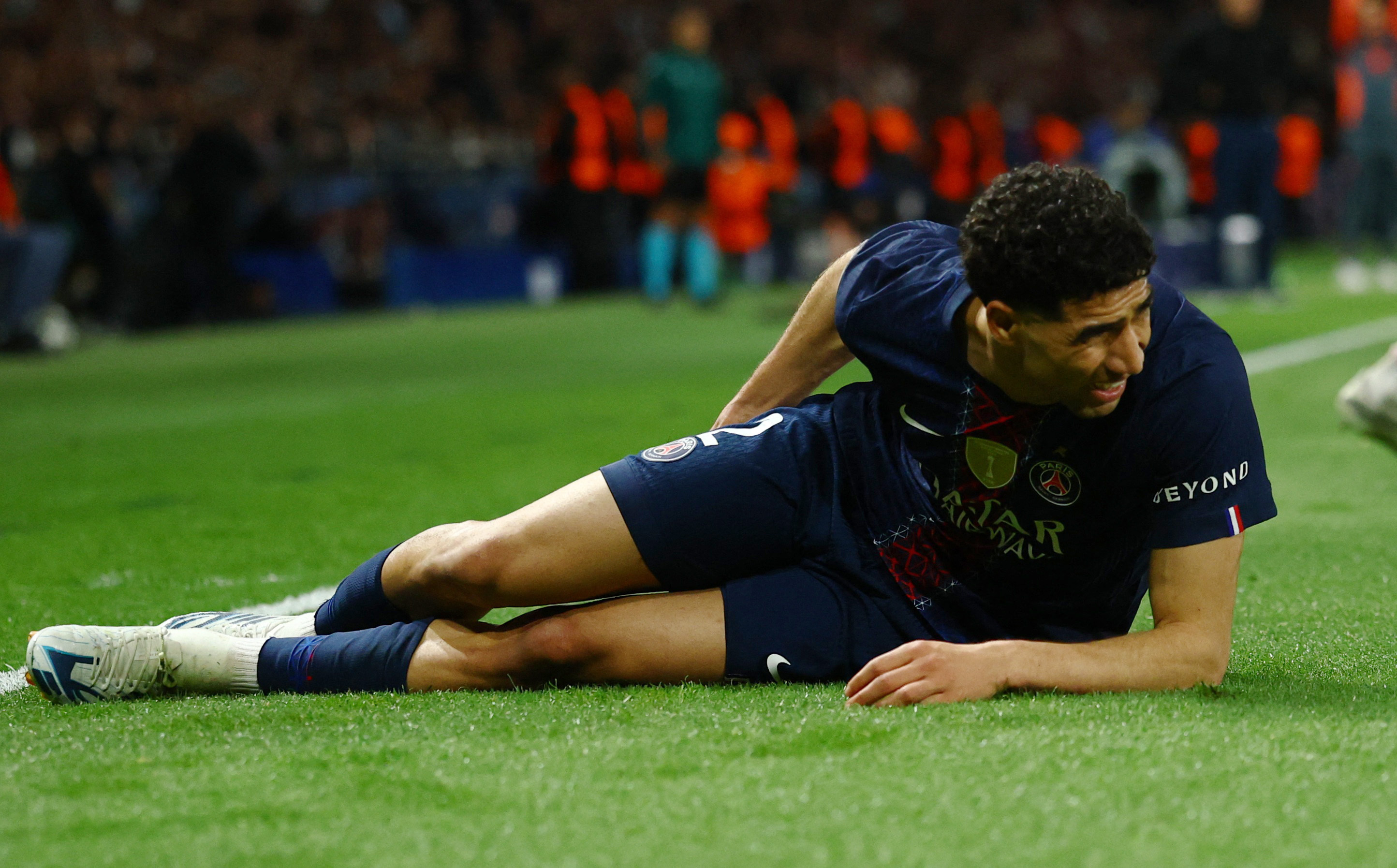 Soccer Football - UEFA Champions League - Semi Final - First Leg - Paris St Germain v Bayern Munich - Parc des Princes, Paris, France - April 28, 2026 Paris St Germain's Achraf Hakimi reacts after sustaining an injury REUTERS/Sarah Meyssonnier