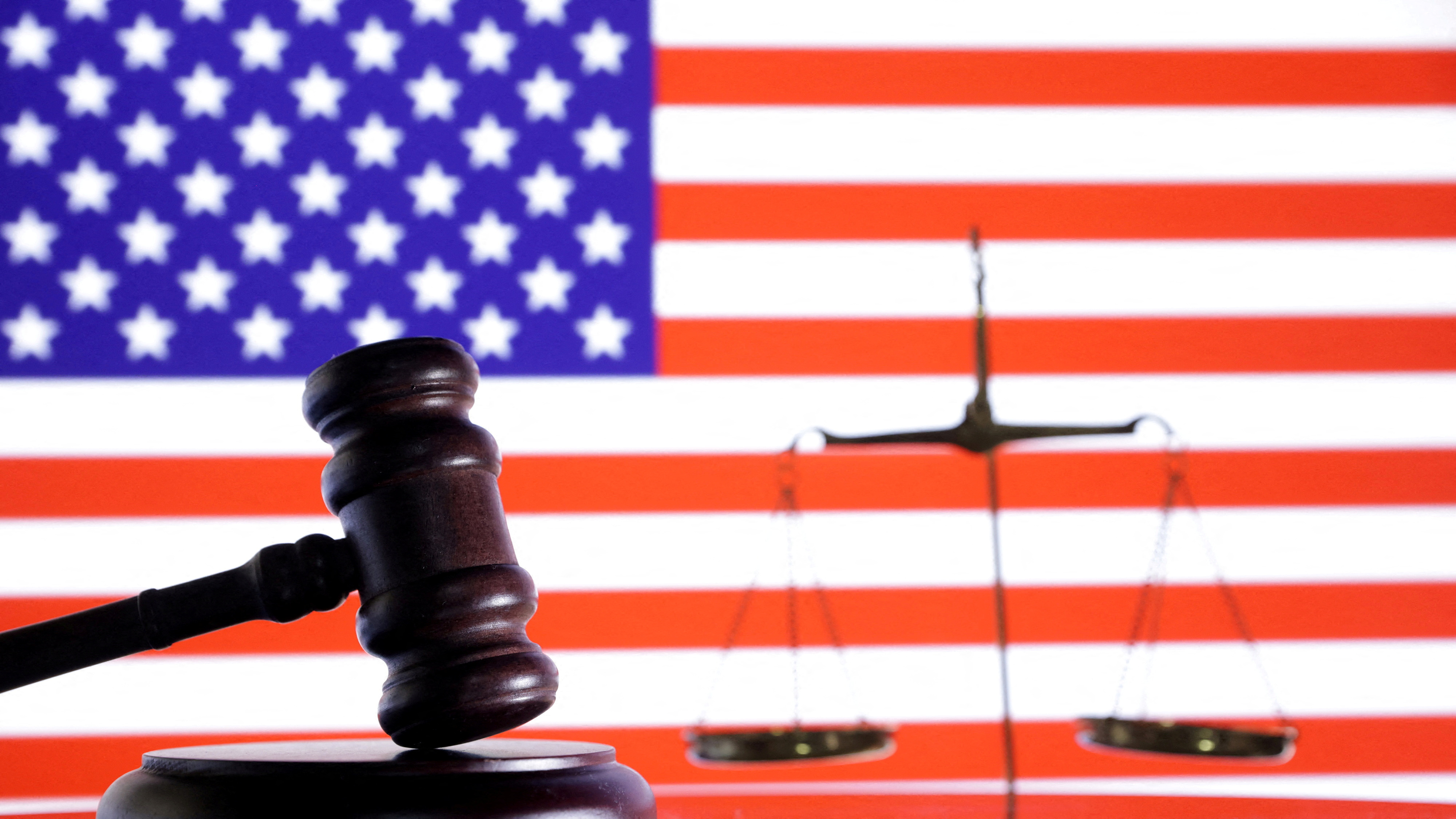 FILE PHOTO: The U.S. flag, a judge gavel and a vintage scale