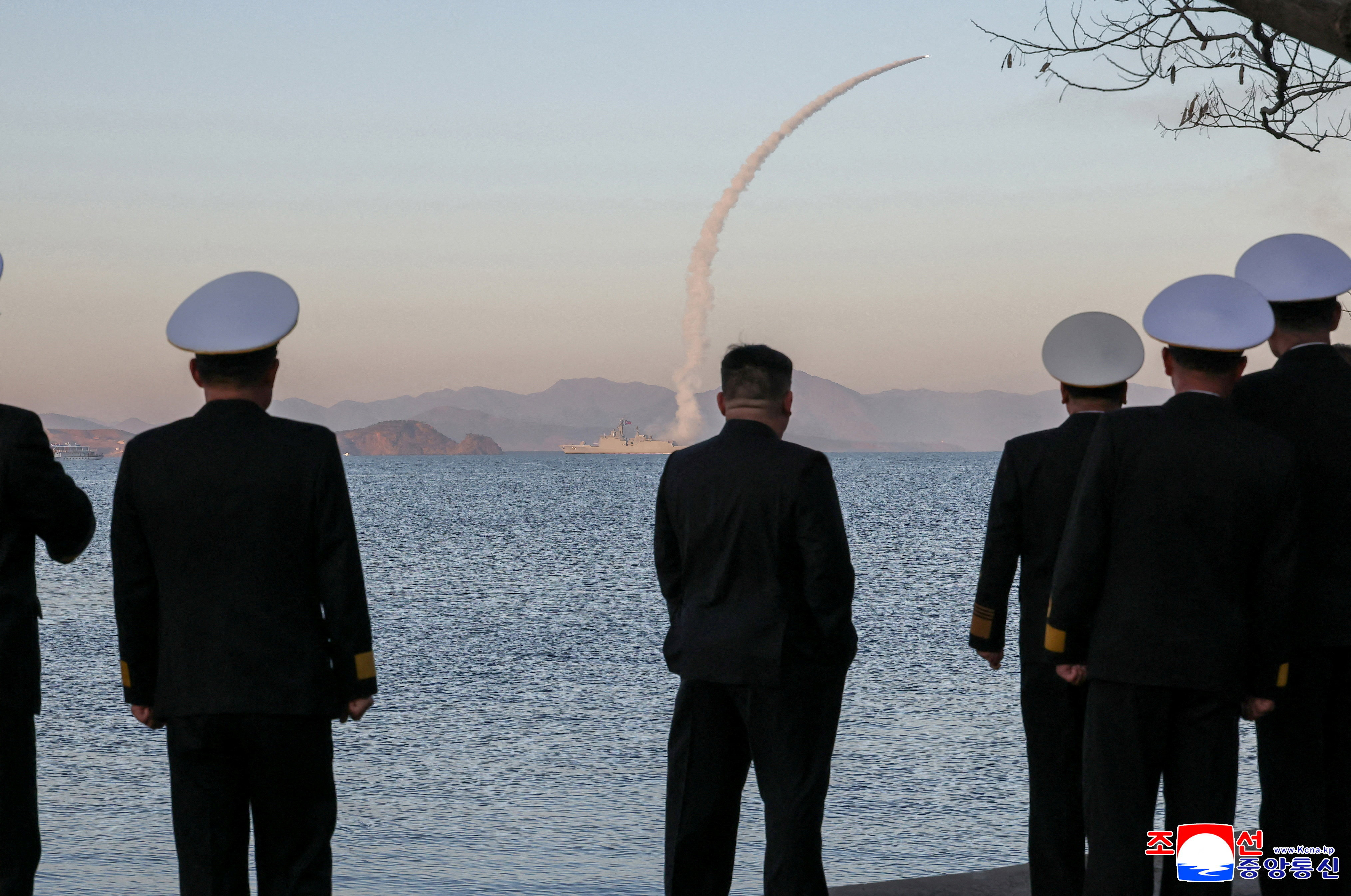 North Korean leader Kim Jong Un observes as strategic cruise missiles and anti-warship missiles are test-fired
