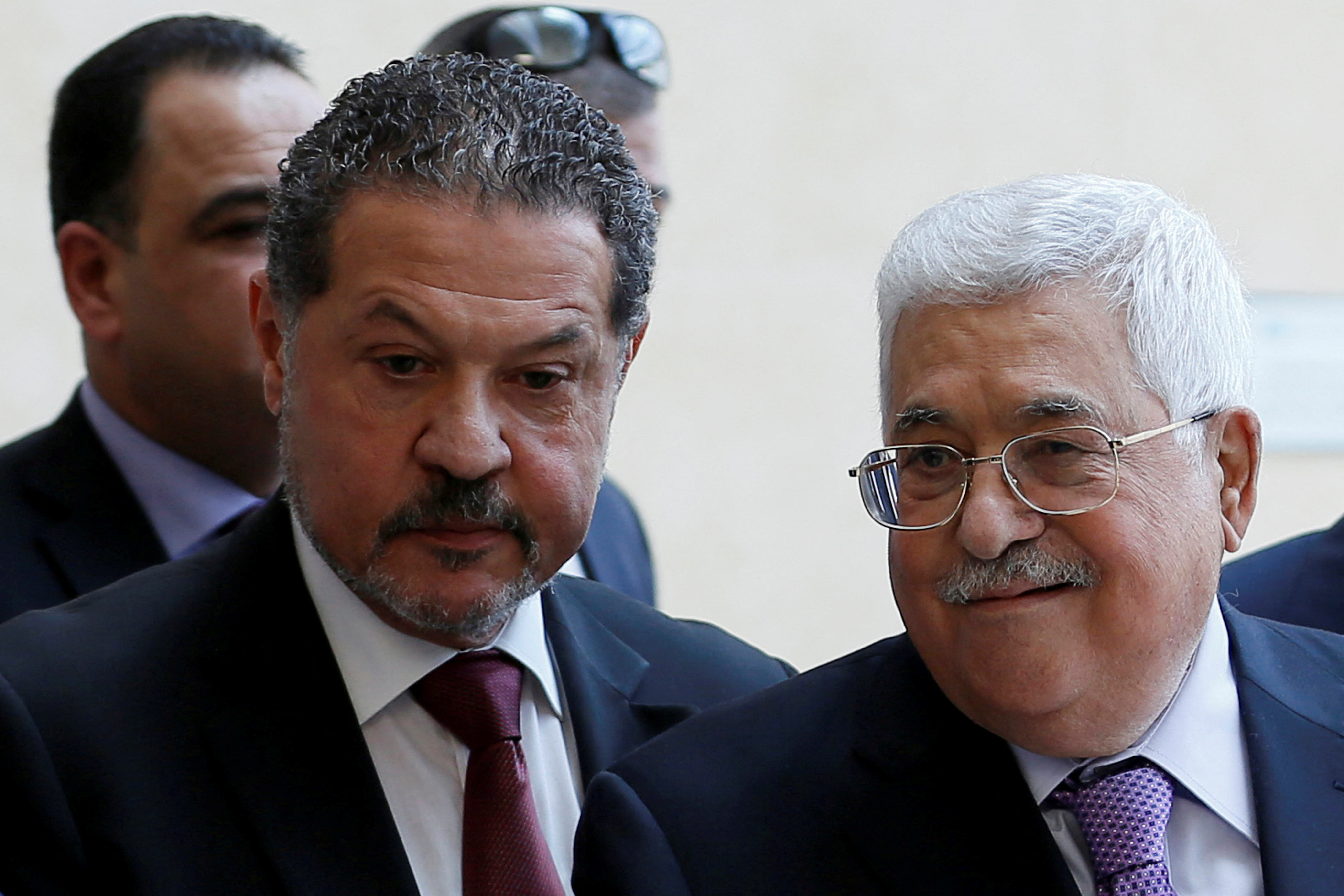 Palestinian President Mahmoud Abbas, accompanied by his son Yasser