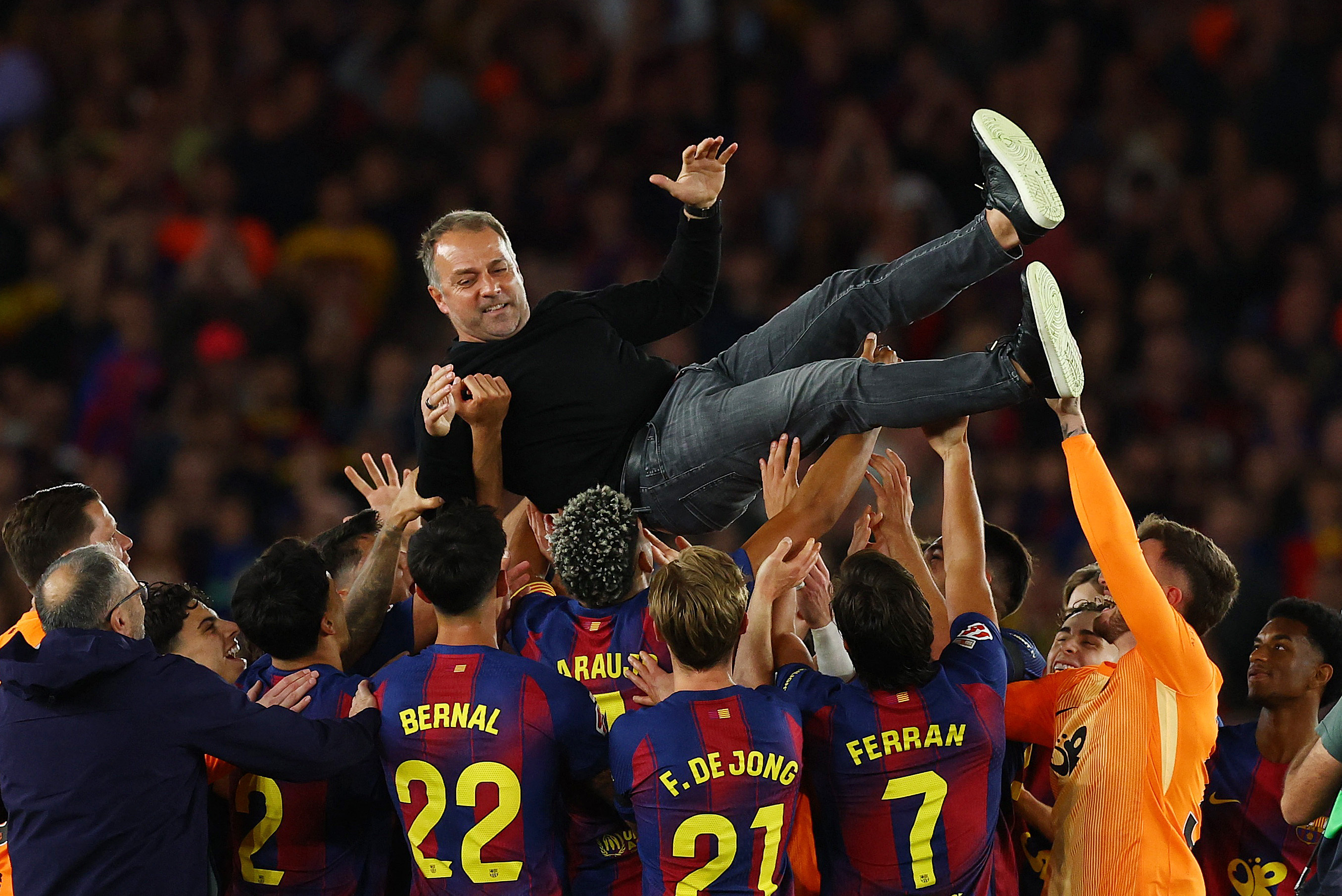 Soccer Football - LaLiga - FC Barcelona v Real Madrid - Spotify Camp Nou, Barcelona, Spain - May 10, 2026 FC Barcelona players throw coach Hansi Flick in the air as they celebrate after winning the LaLiga REUTERS/Albert Gea