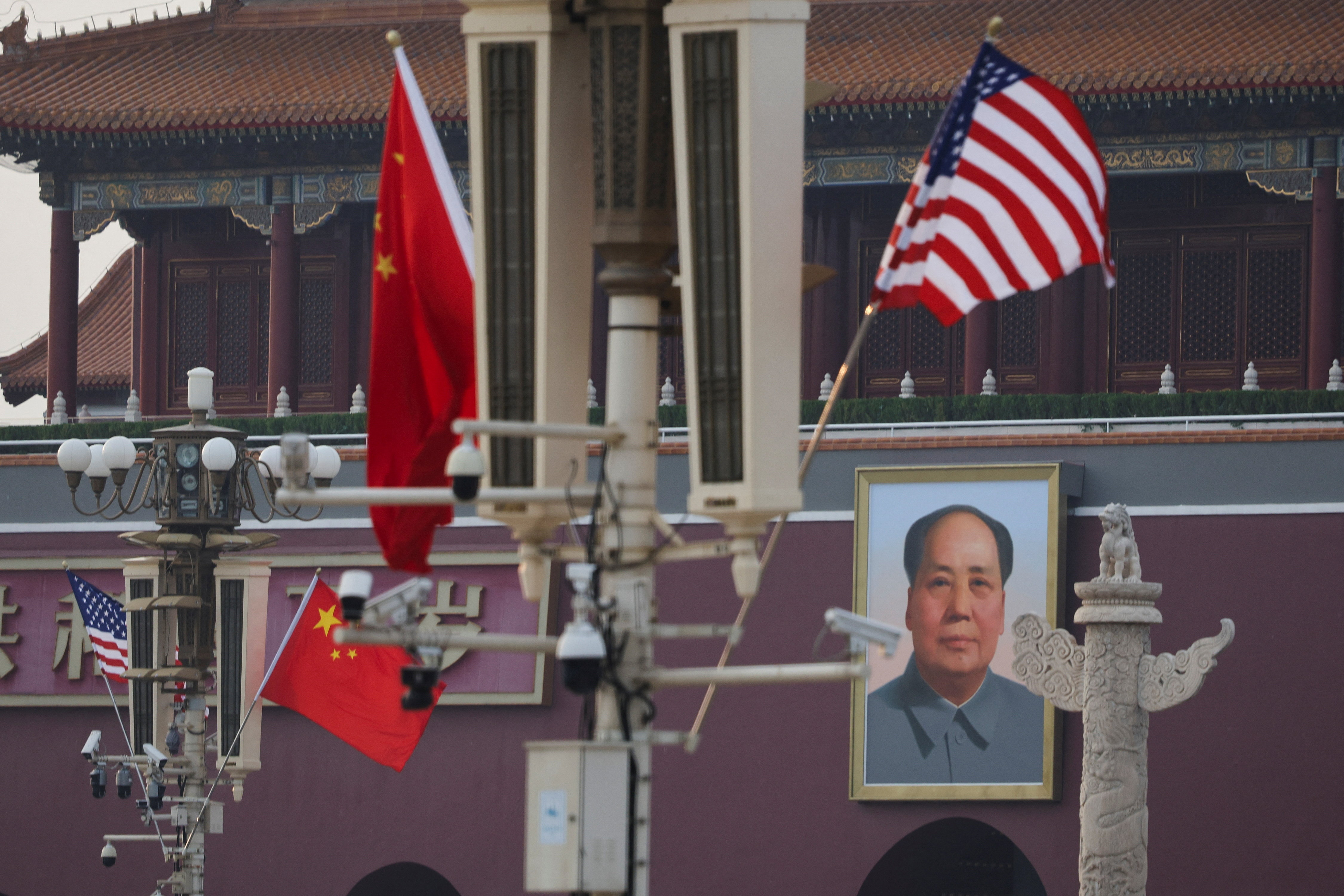 U.S. and Chinese national flags flutter next to the portrait of late Chinese Chairman Mao Zedong, ahead of U.S. President Donald Trump's visit to China, in Beijing, China, May 13, 2026.  REUTERS/Go Nakamura