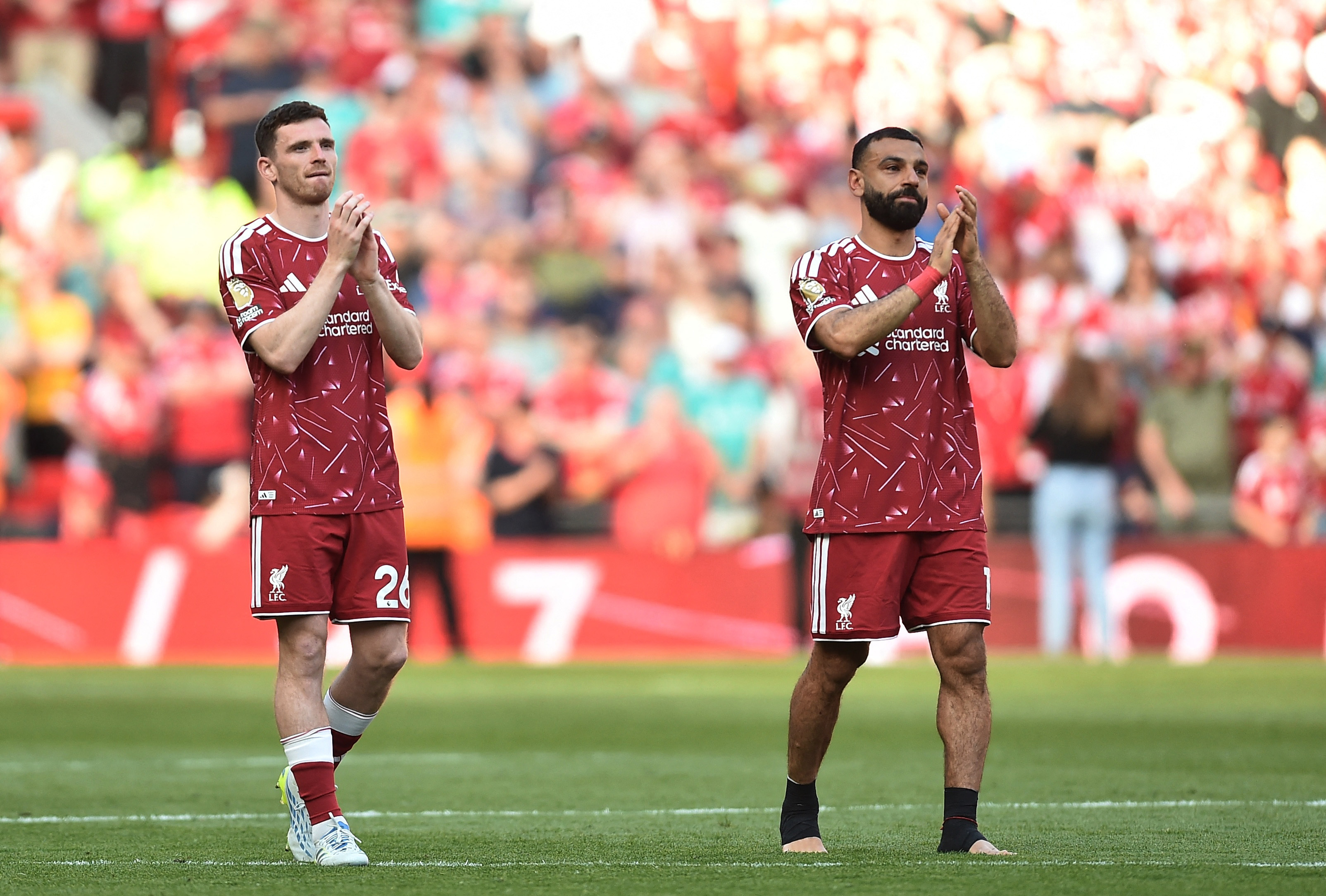 Soccer Football - Premier League - Liverpool v Brentford - Anfield, Liverpool, Britain - May 24, 2026 Liverpool's Andrew Robertson and Mohamed Salah applaud the fans after playing their last match for the club REUTERS/Peter Powell EDITORIAL USE ONLY. NO U
