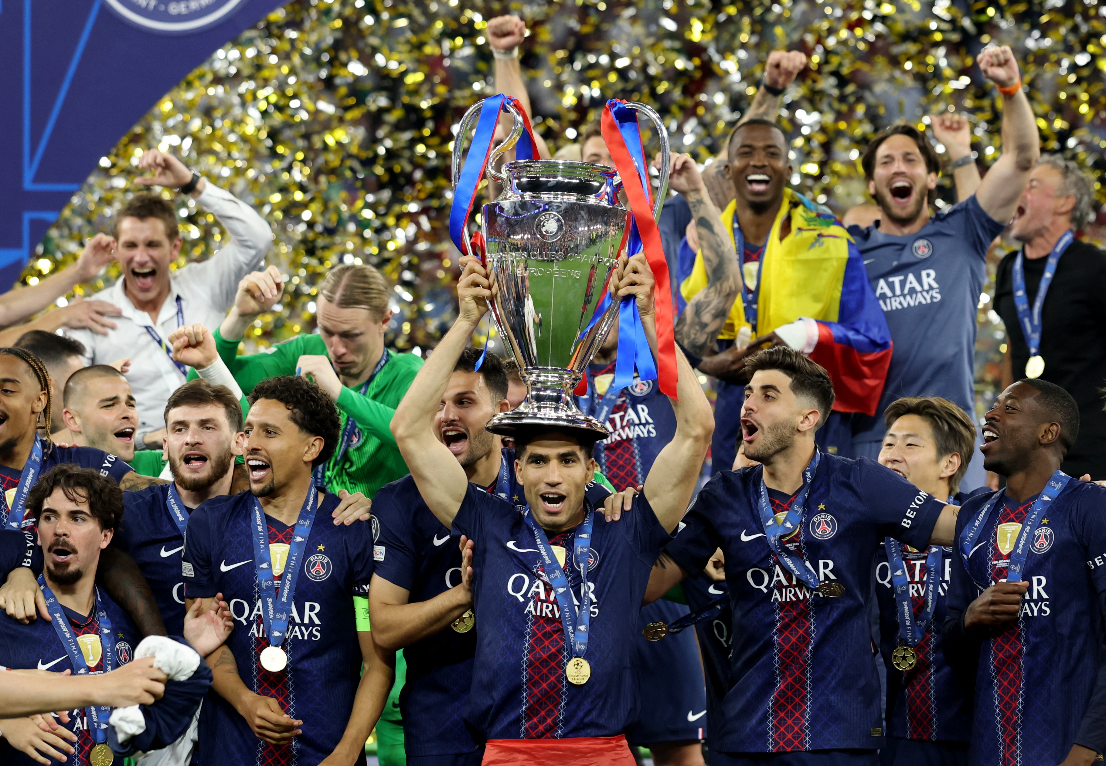 Soccer Football - UEFA Champions League - Final - Paris St Germain v Arsenal - Puskas Arena, Budapest, Hungary - May 30, 2026 Paris St Germain's Achraf Hakimi with the trophy as he celebrates with players after winning the UEFA Champions League REUTERS/Ph