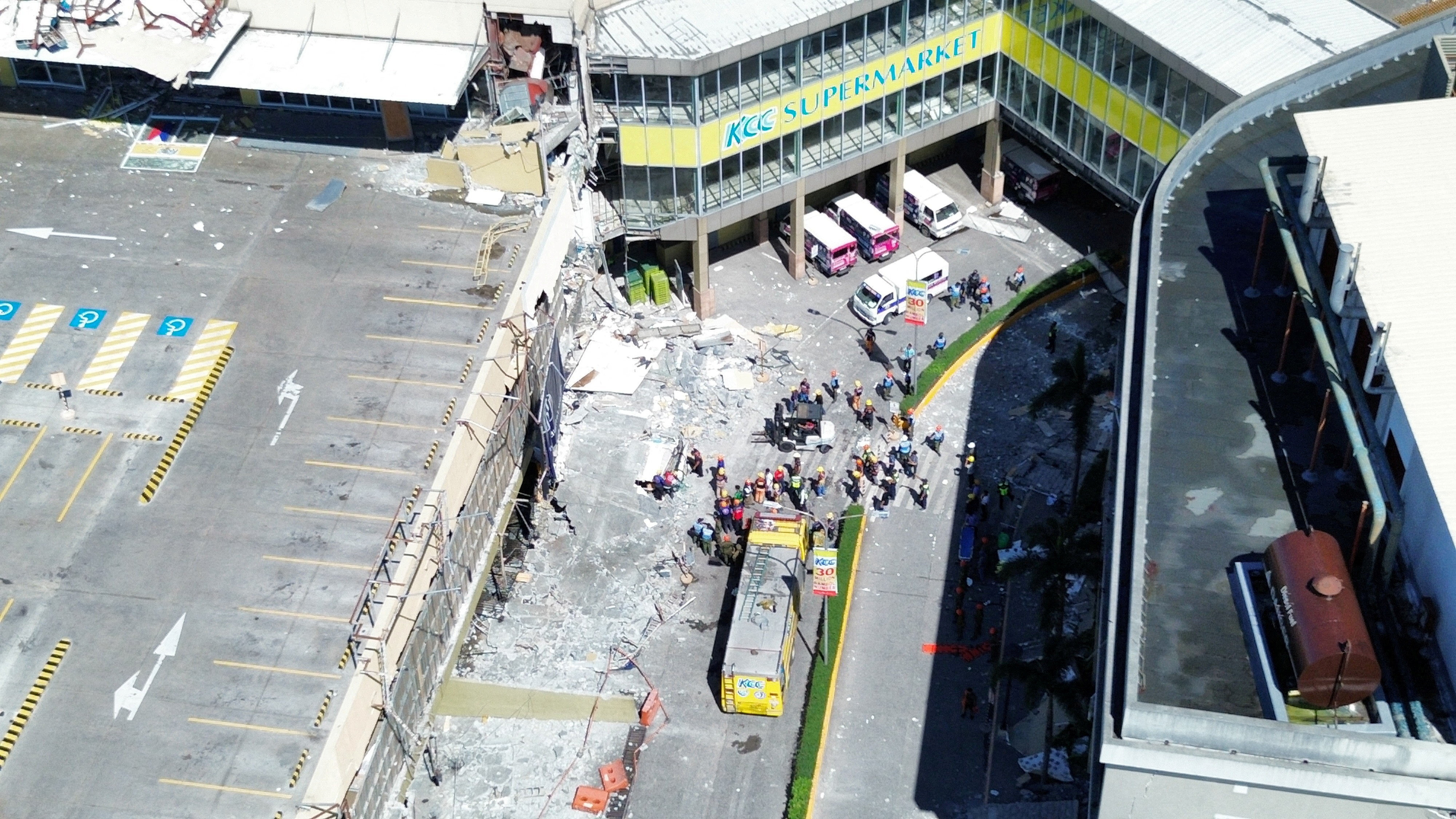 A drone view shows emergency personnel and people