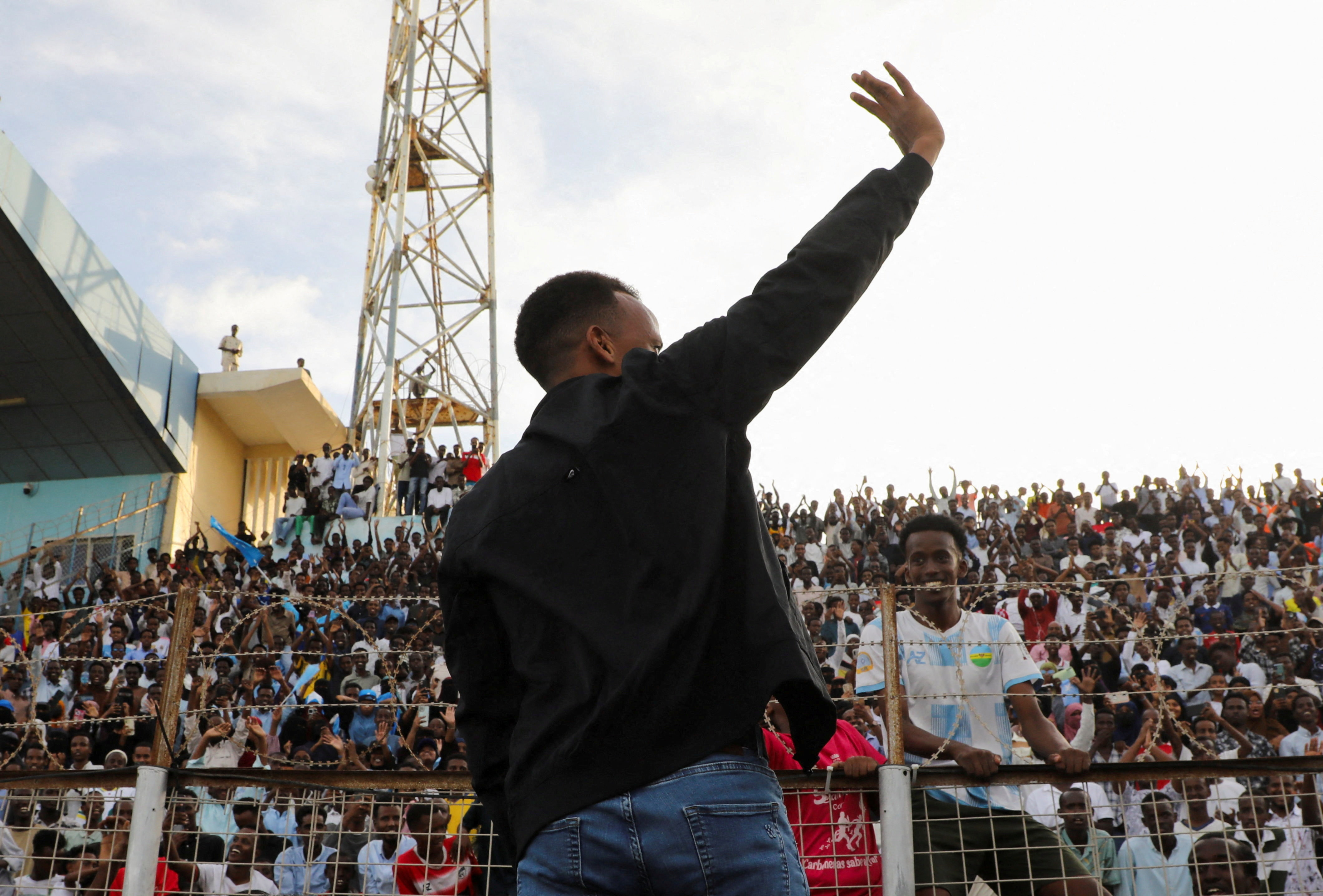 Somali referee Omar Abdulkadir Artan, who was expected to officiate at matches during the 2026. FIFA World Cup but was denied entry to U.S., waves towards fans at the Mogadishu stadium, in Mogadishu, Somalia, June 10, 2026. REUTERS/Feisal Omar     TPX IMA